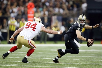 NEW ORLEANS, LA - NOVEMBER 09:  Drew Brees #9 of the New Orleans Saints is pressured by Justin Smith #94 of the San Francisco 49ers during the second quarter of a game at the Mercedes-Benz Superdome on November 9, 2014 in New Orleans, Louisiana.  (Photo b