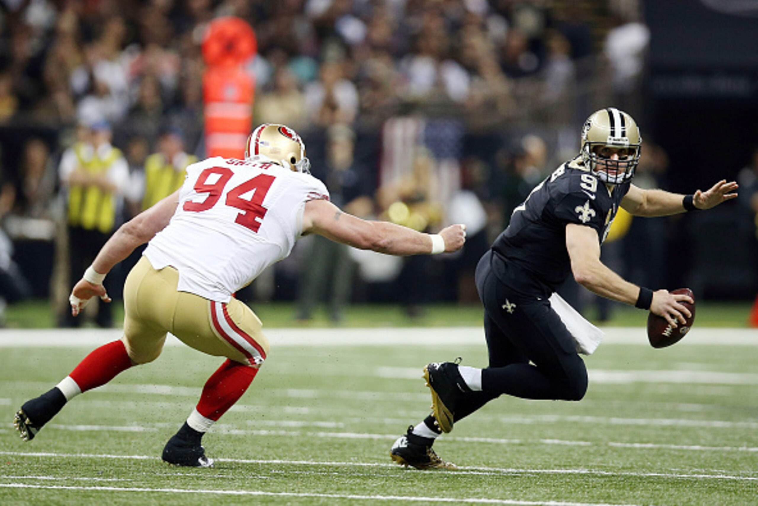 NEW ORLEANS, LA - NOVEMBER 09:  Drew Brees #9 of the New Orleans Saints is pressured by Justin Smith #94 of the San Francisco 49ers during the second quarter of a game at the Mercedes-Benz Superdome on November 9, 2014 in New Orleans, Louisiana.  (Photo b
