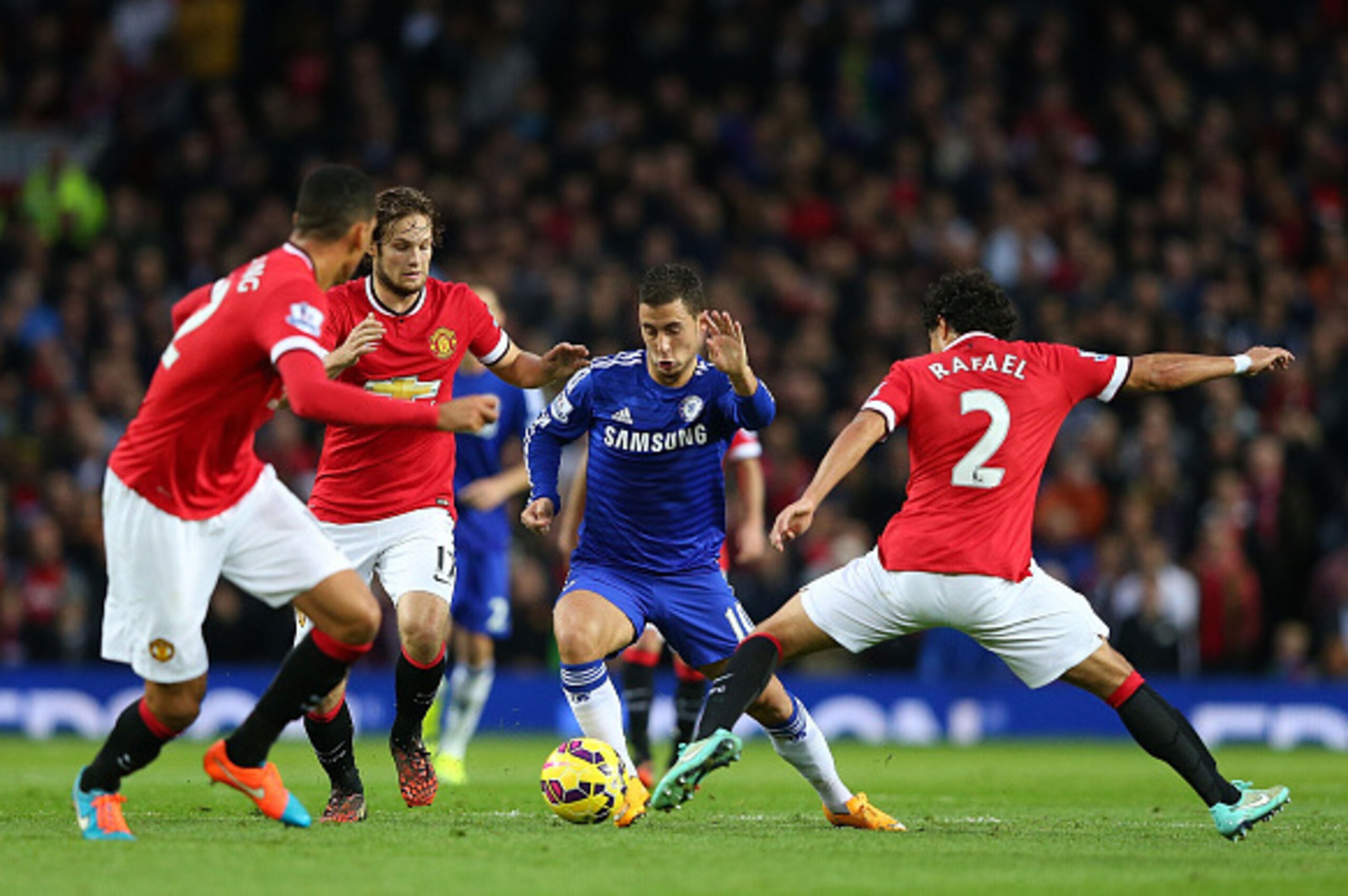 MANCHESTER, ENGLAND - OCTOBER 26: Rafael of Manchester United challenges Eden Hazard of Chelsea during the Barclays Premier League match between Manchester United and Chelsea at Old Trafford on October 26, 2014 in Manchester, England. (Photo by Alex Liv MANCHESTER, ENGLAND - OCTOBER 26: Rafael of Manchester United challenges Eden Hazard of Chelsea during the Barclays Premier League match between Manchester United and Chelsea at Old Trafford on October 26, 2014 in Manchester, England. (Photo by Alex Liv