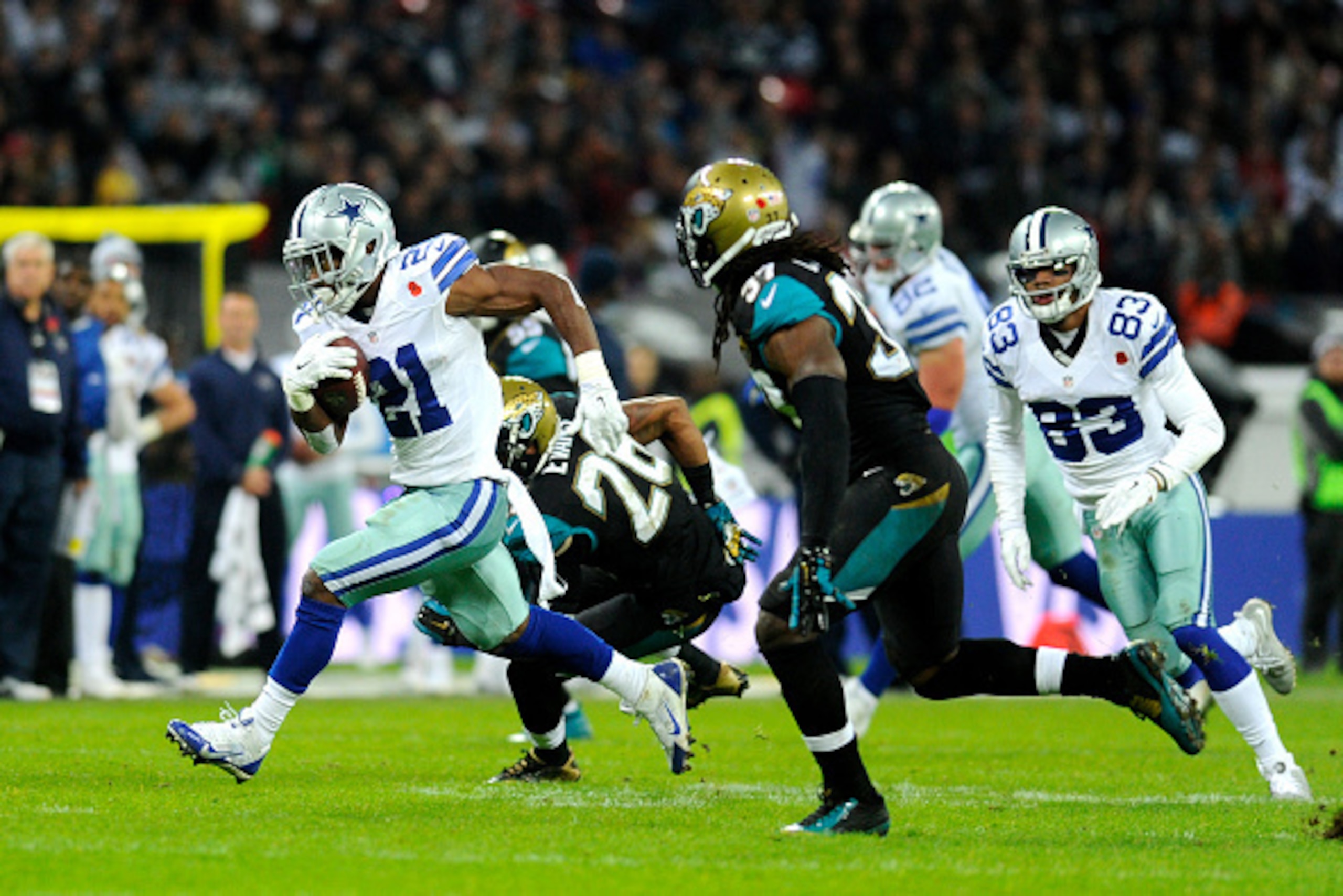 LONDON, ENGLAND - NOVEMBER 09:  Joseph Randle #21 of the Dallas Cowboys bursts upfield during the NFL week 10 match between the Jackson Jaguars and the Dallas Cowboys at Wembley Stadium on November 9, 2014 in London, England.  (Photo by Alan Crowhurst/Get