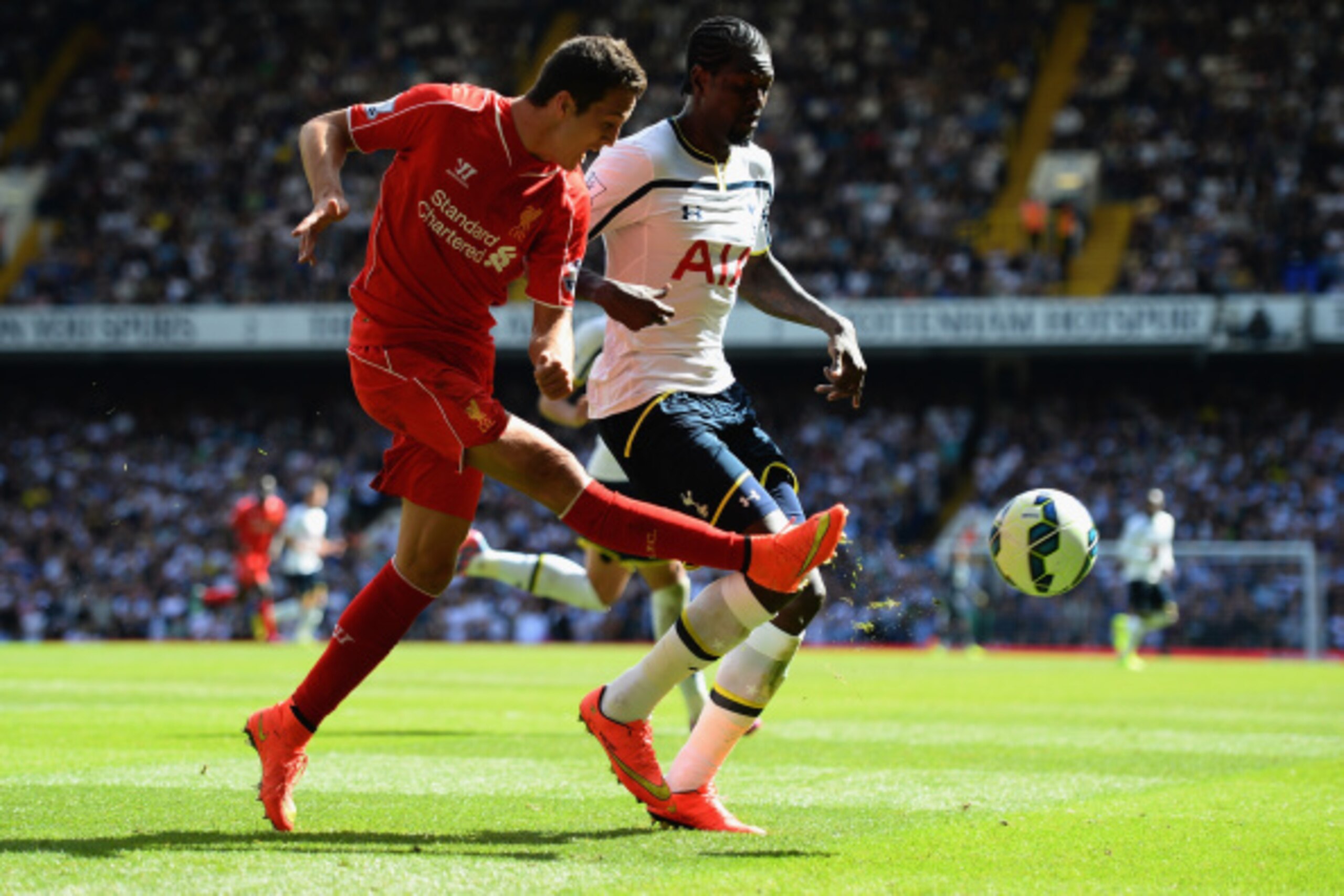 LONDON, ENGLAND - AUGUST 31:  Emmanuel Adebayour of Spurs and Javi Manquillo of Liverpool battle for the ba;; during the Barclays Premier League match between Tottenham Hotspur and Liverpool at White Hart Lane on August 31, 2014 in London, England.  (Phot