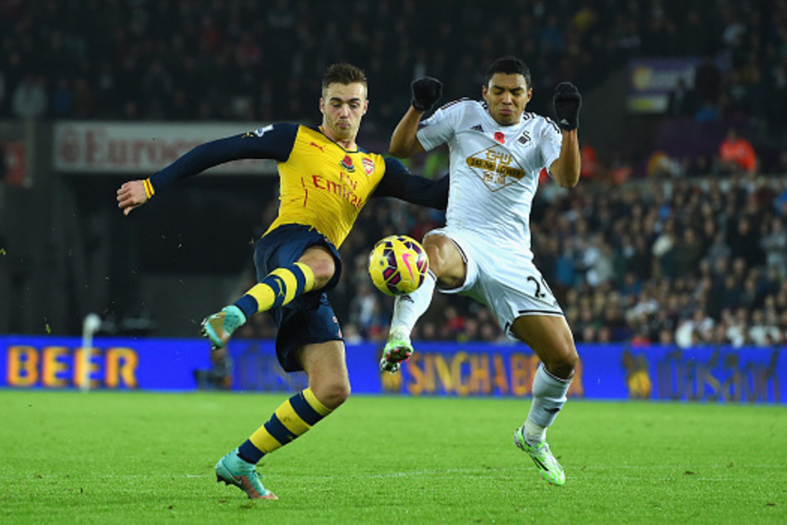 SWANSEA, WALES - NOVEMBER 09: Arsenal player Calum Chambers is challenged by Swansea player Jefferson Montero during the Barclays Premier League match between Swansea City and Arsenal at Liberty Stadium on November 9, 2014 in Swansea, Wales. (Photo by S SWANSEA, WALES - NOVEMBER 09: Arsenal player Calum Chambers is challenged by Swansea player Jefferson Montero during the Barclays Premier League match between Swansea City and Arsenal at Liberty Stadium on November 9, 2014 in Swansea, Wales. (Photo by S
