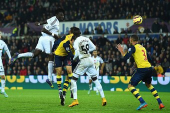 SWANSEA, WALES - NOVEMBER 09:  Swansea player Bafetimbi Gomis (c) heads the second Swansea goal during the Barclays Premier League match between Swansea City and Arsenal at Liberty Stadium on November 9, 2014 in Swansea, Wales.  (Photo by Stu Forster/Gett