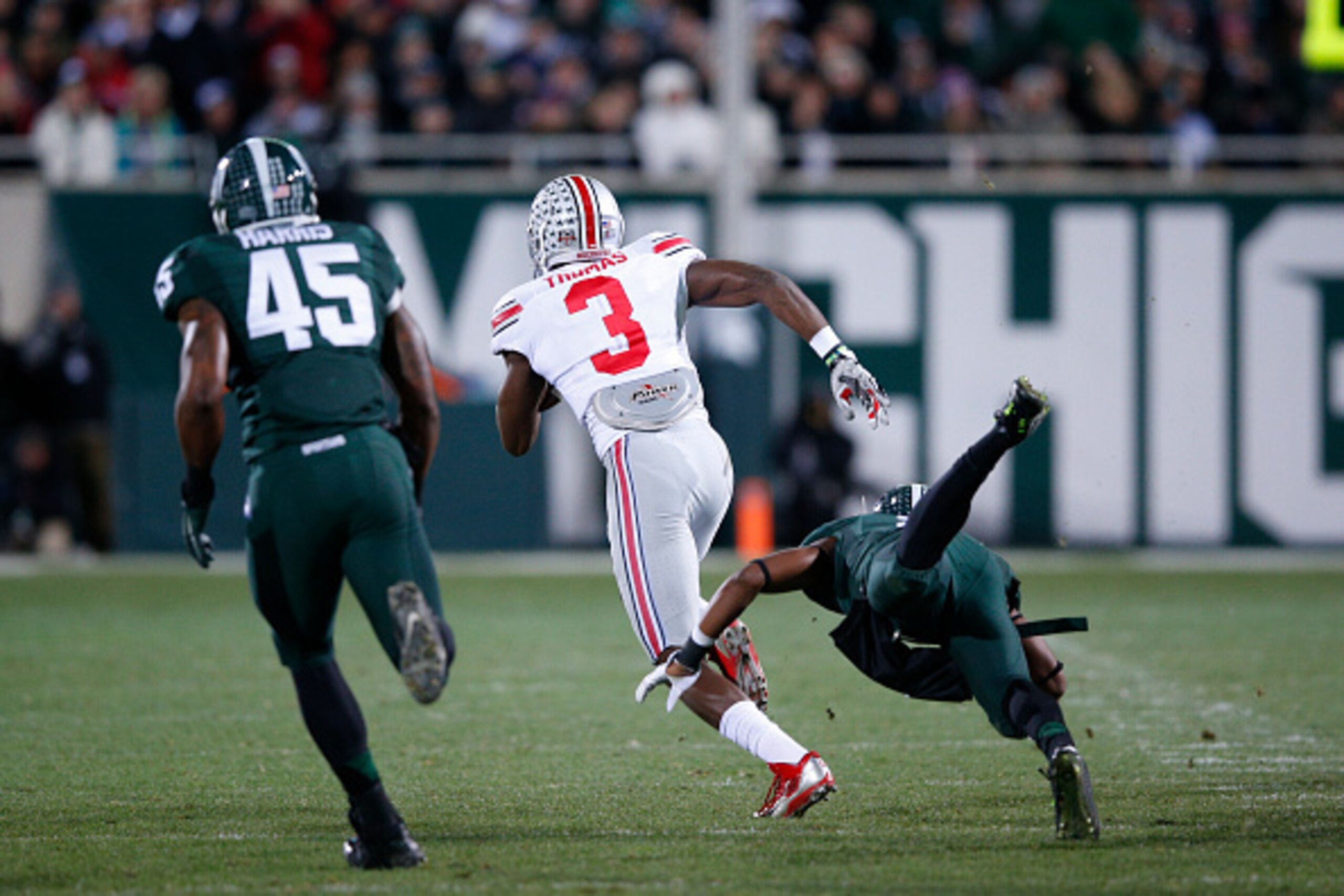 EAST LANSING, MI - NOVEMBER 8: Michael Thomas #3 of the Ohio State Buckeyes runs for a 79-yard touchdown after a reception in the second quarter of the game against the Michigan State Spartans at Spartan Stadium on November 8, 2014 in East Lansing, Michig