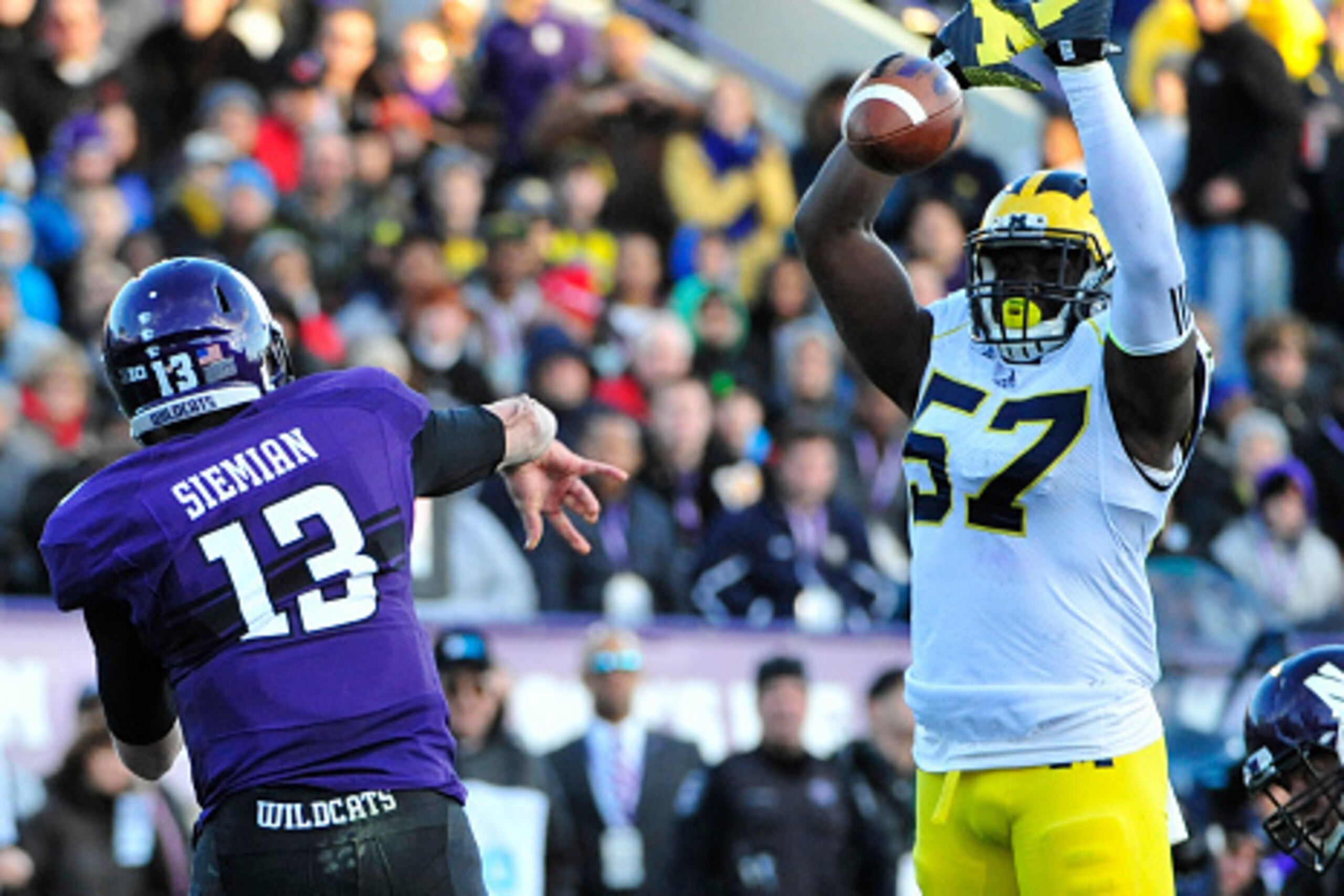 EVANSTON IL - NOVEMBER 08: Frank Clark #57 of the Michigan Wolverines blocks a pass by Trevor Siemian #13 of the Northwestern Wildcats during the first half on November 8, 2014 at Ryan Field in Evanston, Illinois. (Photo by David Banks/Getty Images) EVANSTON IL - NOVEMBER 08: Frank Clark #57 of the Michigan Wolverines blocks a pass by Trevor Siemian #13 of the Northwestern Wildcats during the first half on November 8, 2014 at Ryan Field in Evanston, Illinois. (Photo by David Banks/Getty Images)
