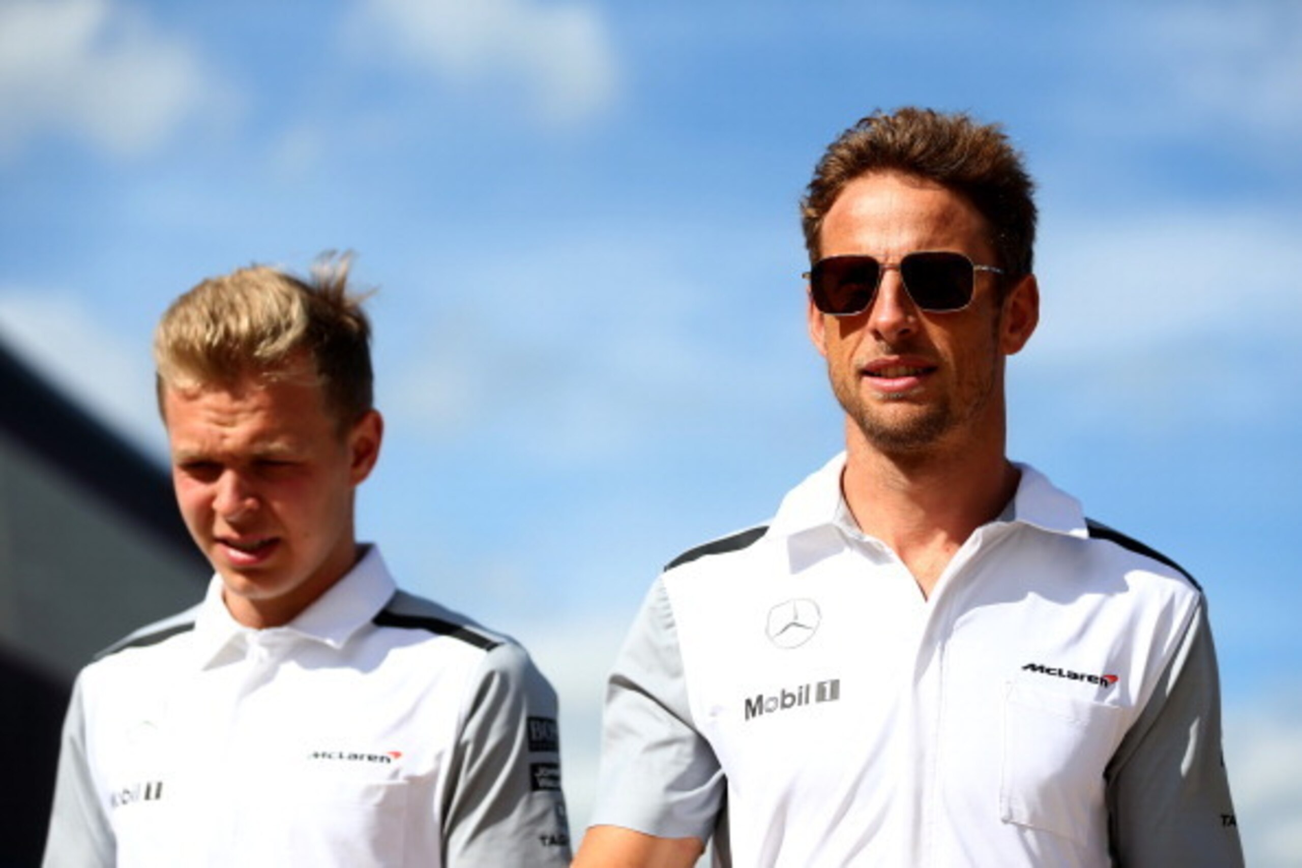 NORTHAMPTON, ENGLAND - JULY 04:  Jenson Button of Great Britain and McLaren and Kevin Magnussen of Denmark and McLaren walk through the paddock after practice ahead of the British Formula One Grand Prix at Silverstone Circuit on July 4, 2014 in Northampto