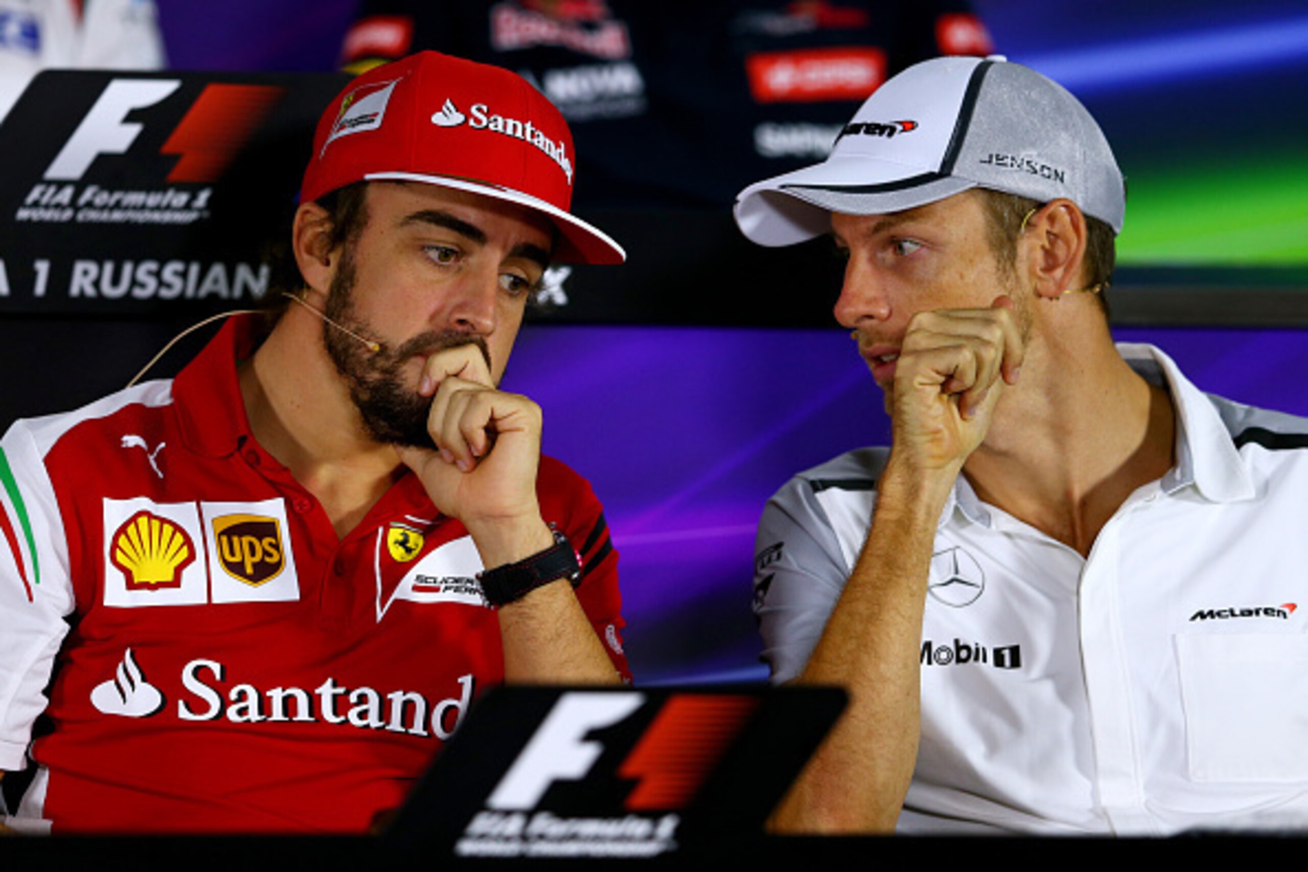 SOCHI, RUSSIA - OCTOBER 09:  Fernando Alonso of Spain and Ferrari speaks with Jenson Button of Great Britain and McLaren during a press conference during previews ahead of the Russian Formula One Grand Prix at Sochi Autodrom on October 9, 2014 in Sochi, R