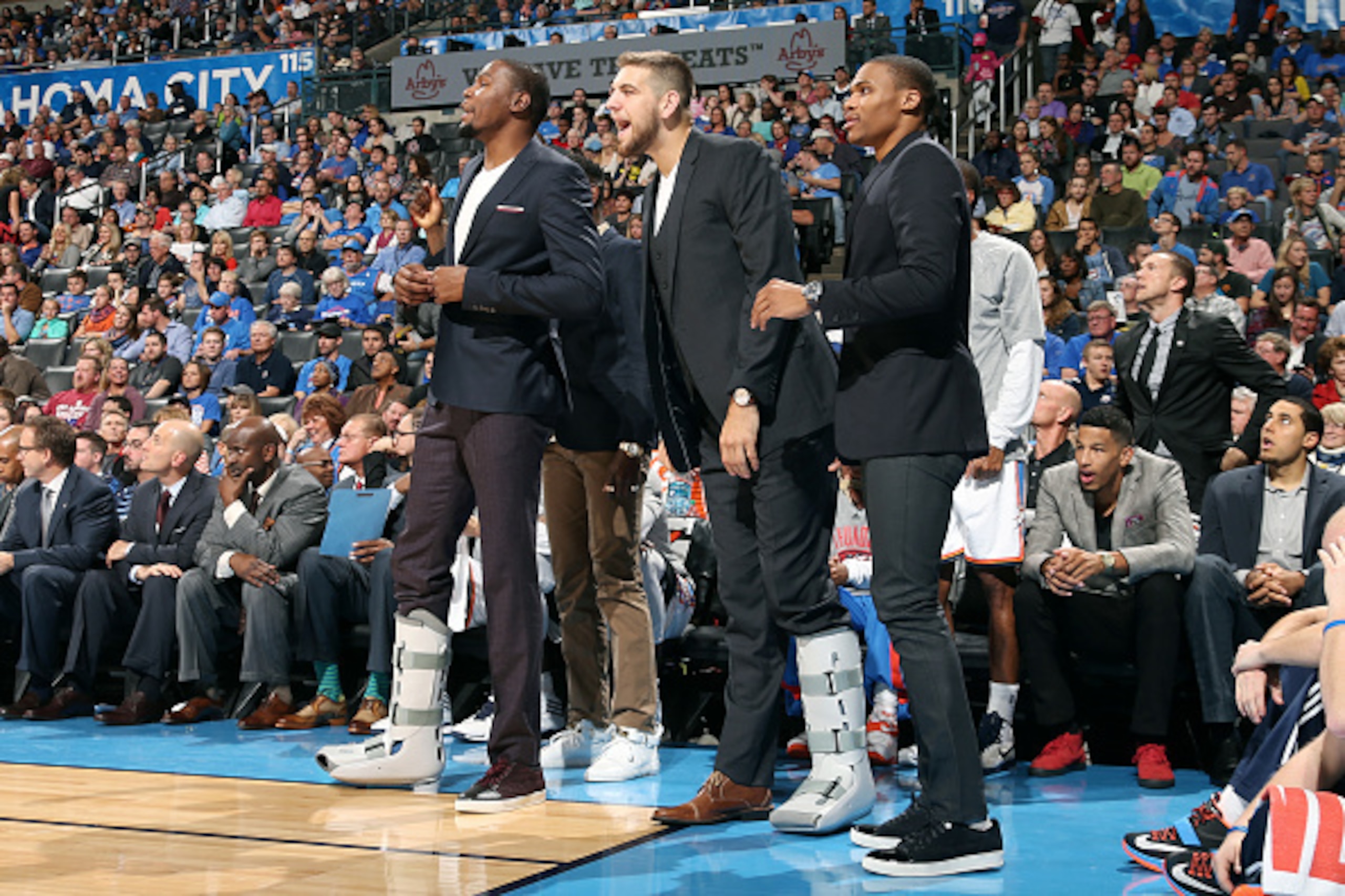 OKLAHOMA CITY, OK- NOVEMBER 9: Kevin Durant #35, Mitch McGary #33, and Russell Westbrook #0 of the Oklahoma City Thunder celebrate on the sideline during a game against the Sacramento Kings on November 9, 2014 at Chesapeake Energy Arena in Oklahoma City, 