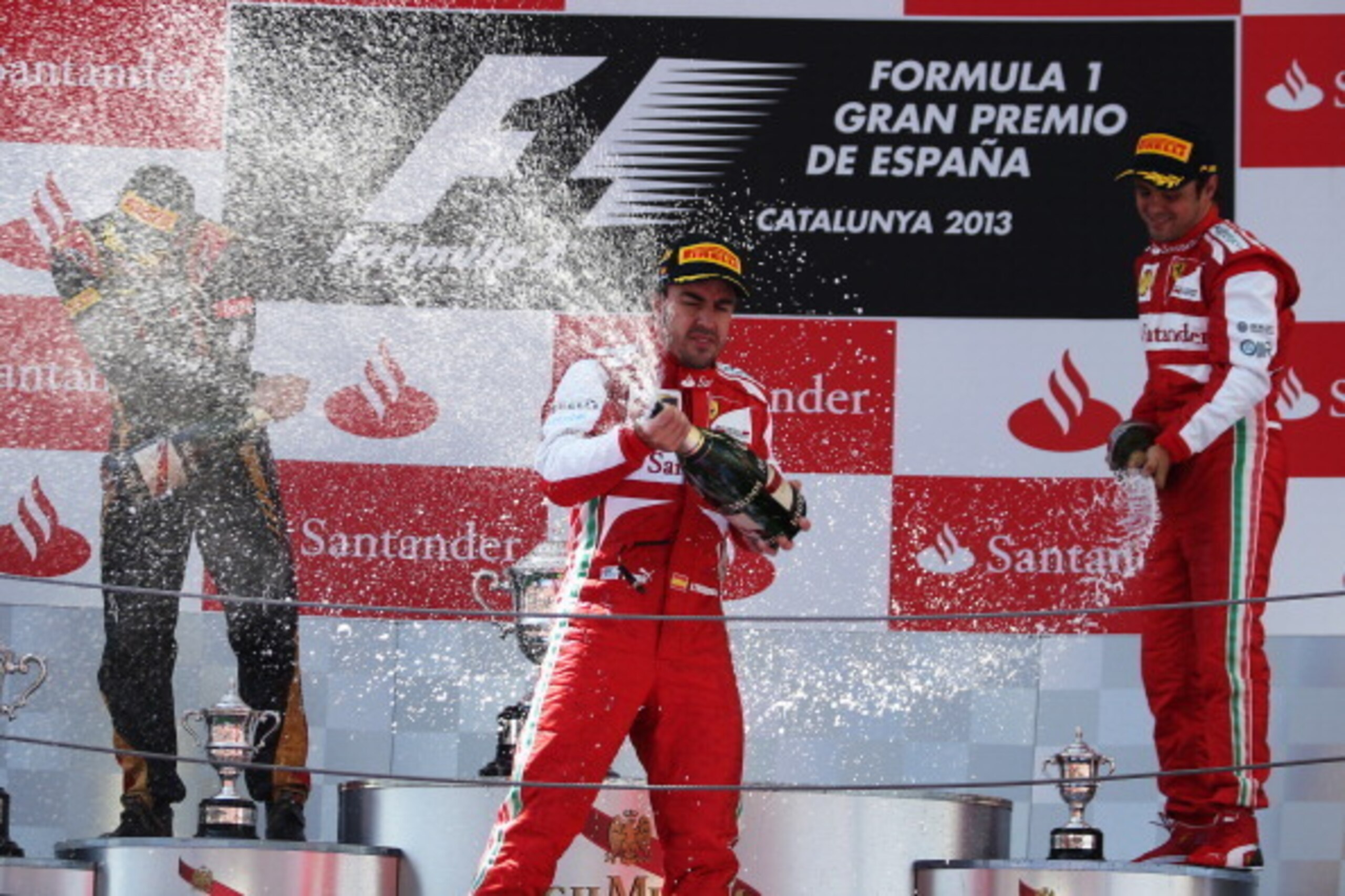 MONTMELO, SPAIN - MAY 12:  Race winner Fernando Alonso (C) of Spain and Ferrari celebrates on the podium with second placed Kimi Raikkonen (L) of Finland and Lotus and third placed Felipe Massa of Brazil and Ferrari following the Spanish Formula One Grand