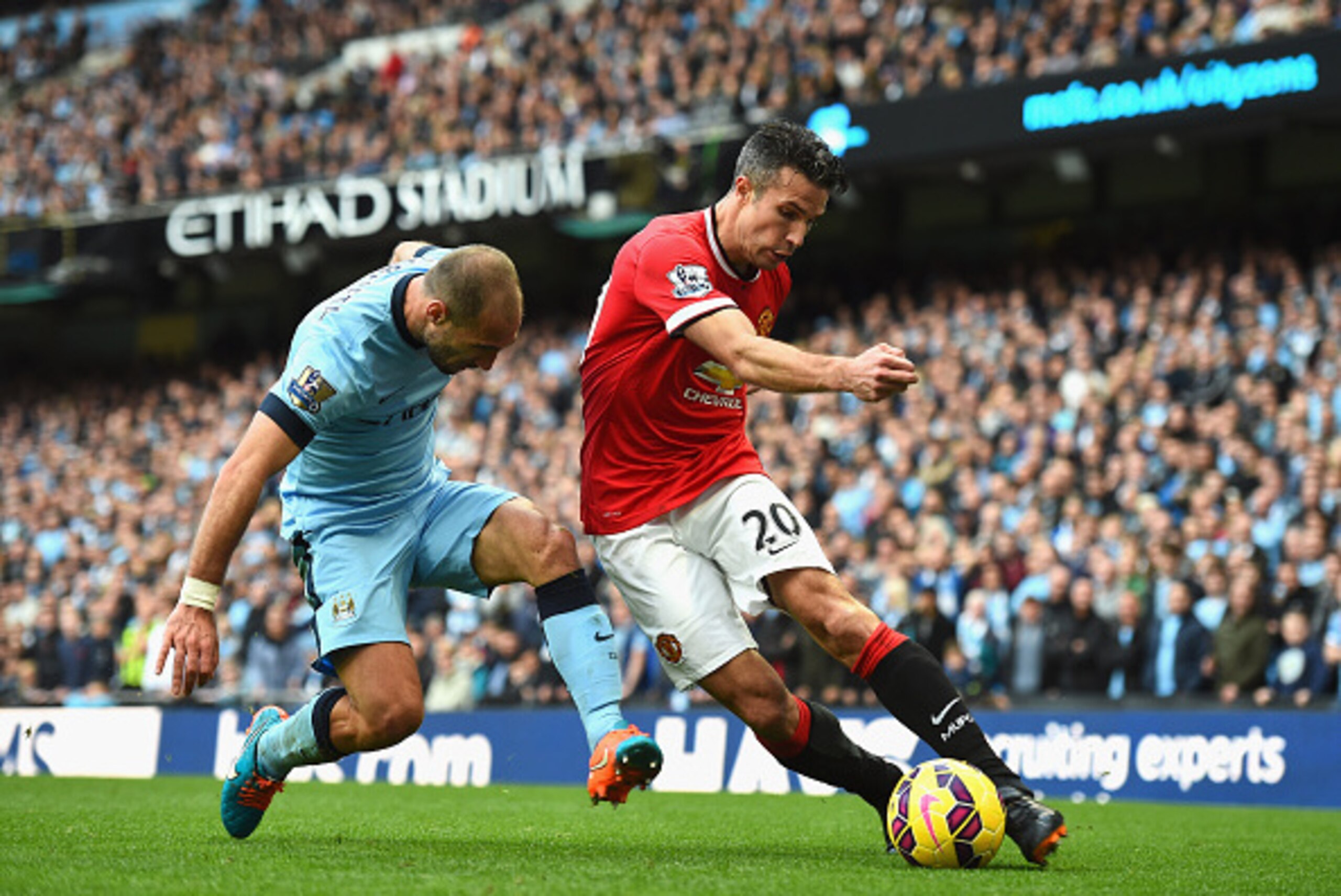 MANCHESTER, ENGLAND - NOVEMBER 02:  Pablo Zabaleta of Manchester City tackles Robin van Persie of Manchester United during the Barclays Premier League match between Manchester City and Manchester United at Etihad Stadium on November 2, 2014 in Manchester,