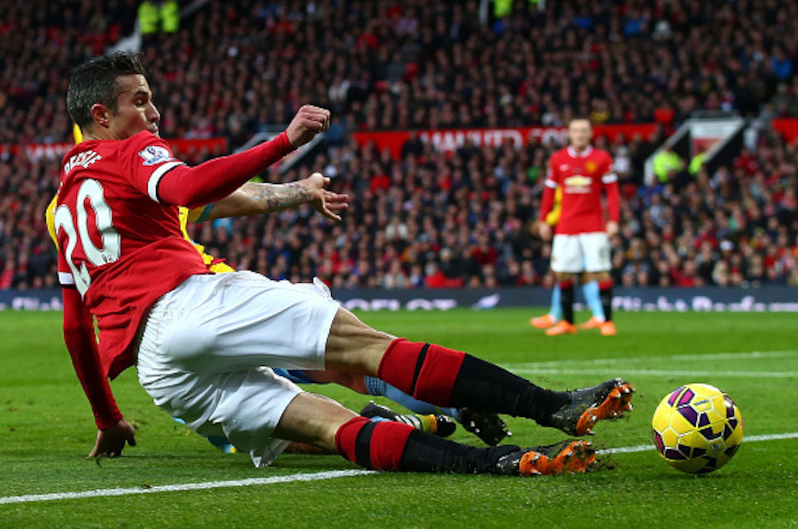 MANCHESTER, ENGLAND - NOVEMBER 08:  Robin van Persie of Manchester United slides in for the ball during the Barclays Premier League match between Manchester United and Crystal Palace at Old Trafford on November 8, 2014 in Manchester, England.  (Photo by C