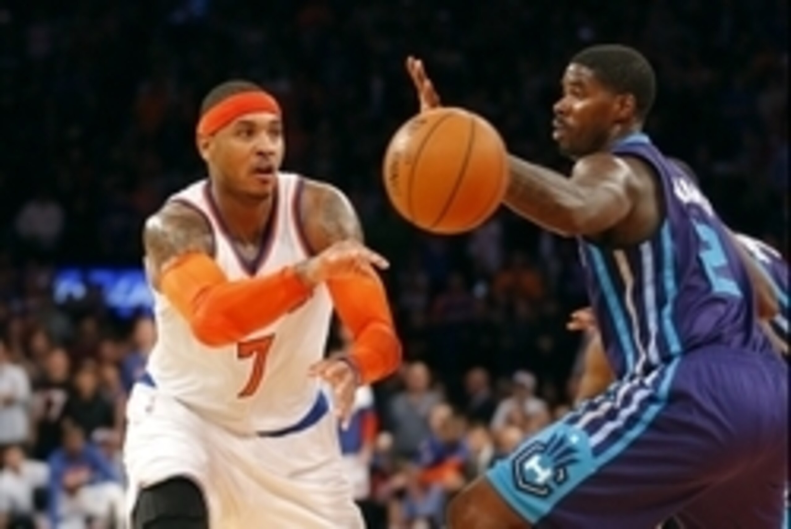 Nov 2, 2014; New York, NY, USA;  New York Knicks forward Carmelo Anthony (7) passes the ball against Charlotte Hornets forward Marvin Williams (2) at Madison Square Garden. New York Knicks defeat the Charlotte Hornets 96-93. Mandatory Credit: Jim O'Connor