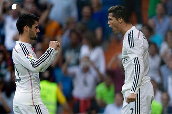 MADRID, SPAIN - OCTOBER 25: Cristiano Ronaldo (R) of Real Madrid CF celebrates scoring their opening goal with teammate Francisco Roman Alarcon alias Isco (L) during the La Liga match between Real Madrid CF and FC Barcelona at Estadio Santiago Bernabeu on