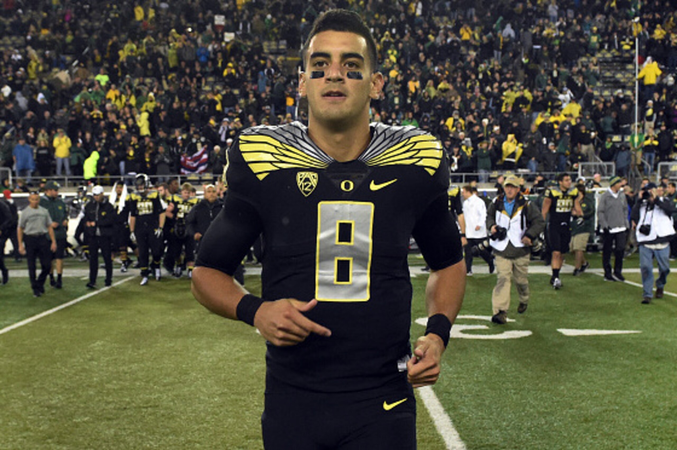 EUGENE, OR - NOVEMBER 1: Quarterback Marcus Mariota #8 of the Oregon Ducks runs out onto the field after the game against the Stanford Cardinal at Autzen Stadium on November 1, 2014 in Eugene, Oregon. Oregon won the game 45-16.(Photo by Steve Dykes/Getty 