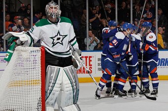 UNIONDALE, NY - OCTOBER 25: The New York Islanders celebrate a goal by Lubomir Visnovsky #11 against Anders Lindback #29 of the Dallas Stars during the second period at the Nassau Veterans Memorial Coliseum on October 25, 2014 in Uniondale, New York.  (Ph