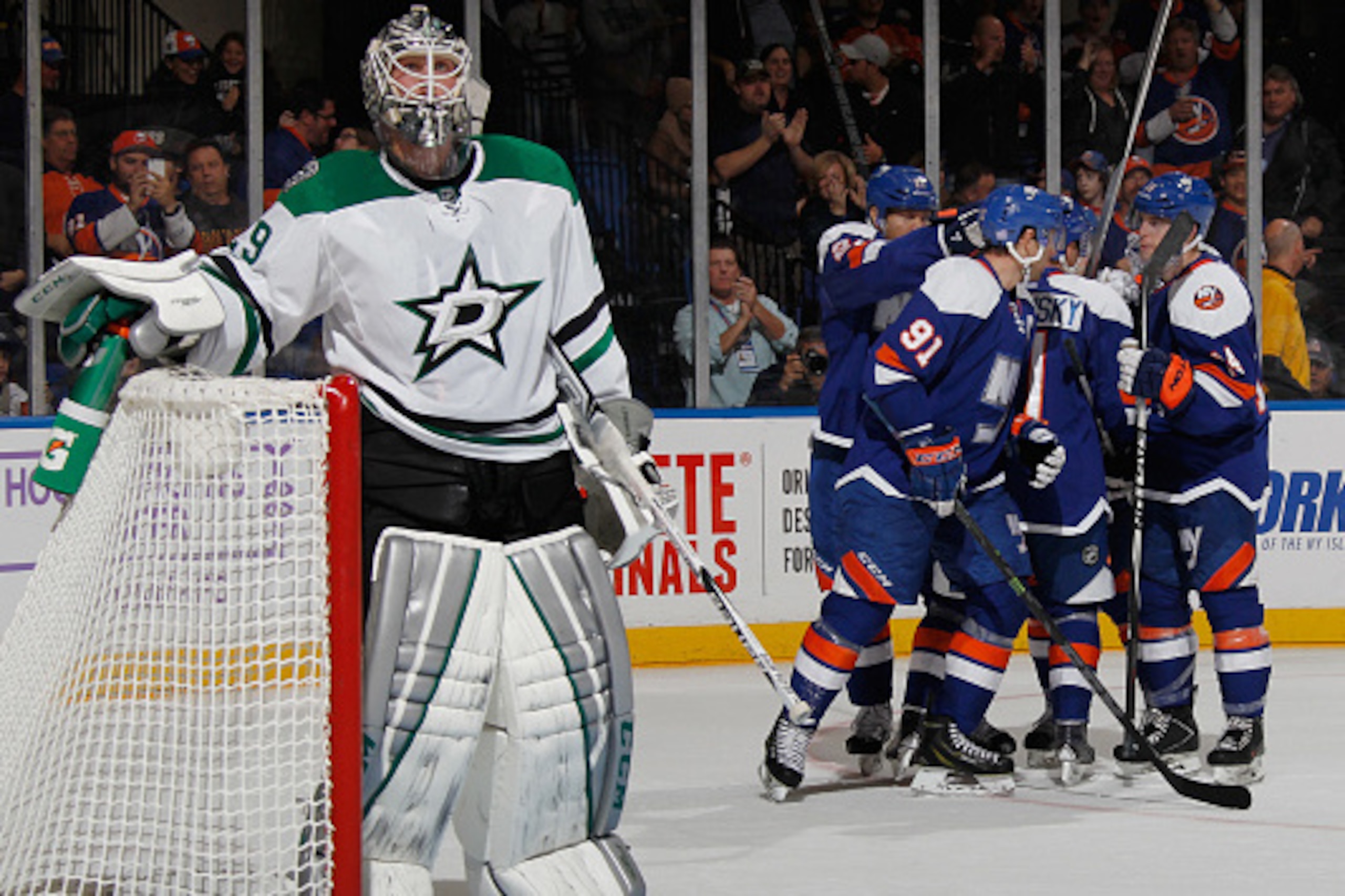 UNIONDALE, NY - OCTOBER 25: The New York Islanders celebrate a goal by Lubomir Visnovsky #11 against Anders Lindback #29 of the Dallas Stars during the second period at the Nassau Veterans Memorial Coliseum on October 25, 2014 in Uniondale, New York.  (Ph