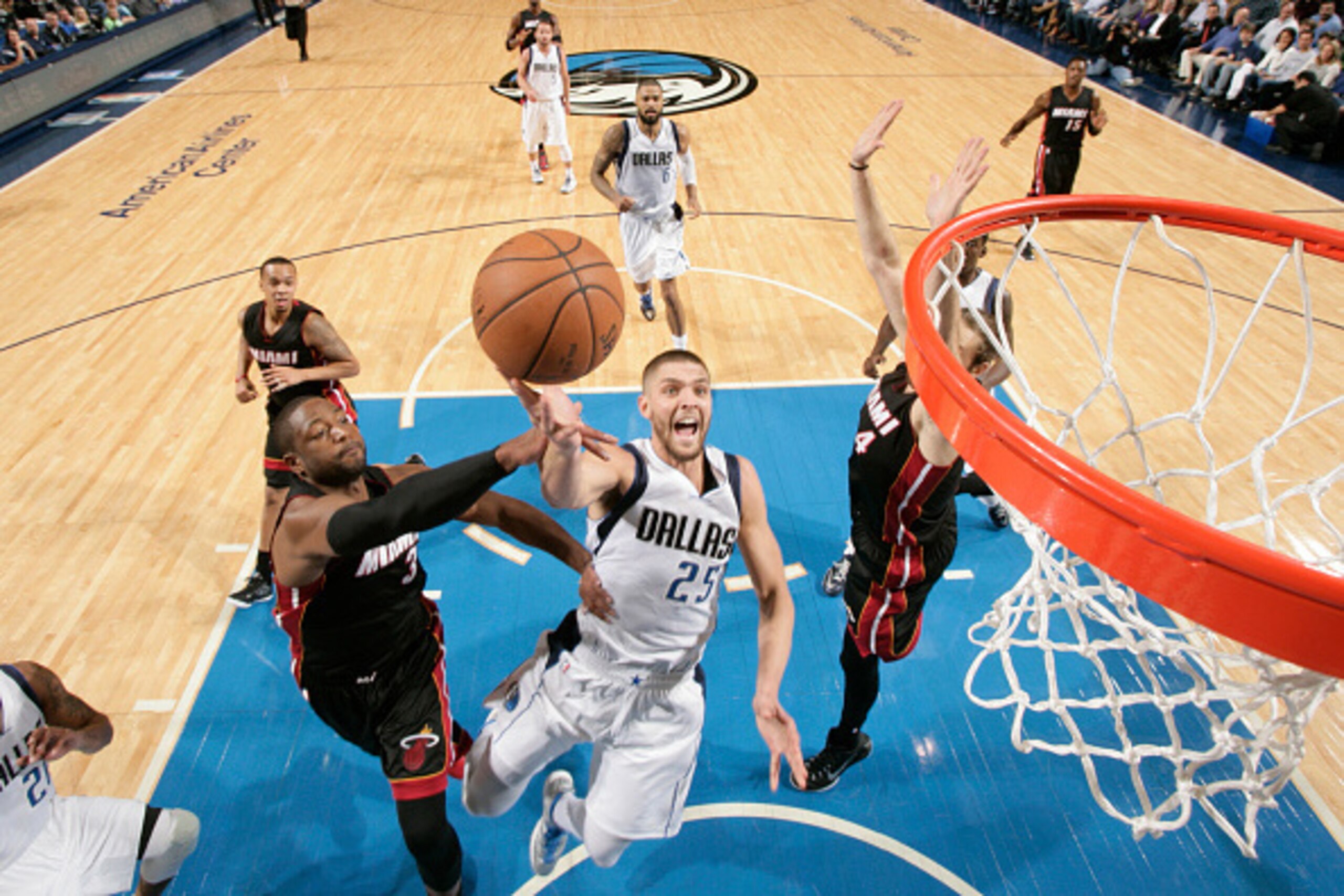 DALLAS, TX - NOVEMBER 9: Chandler Parsons #25 of the Dallas Mavericks goes in for the lay up against Dwyane Wade #3 of the Miami Heat on November 9, 2014 at the American Airlines Center in Dallas, Texas. NOTE TO USER: User expressly acknowledges and agree