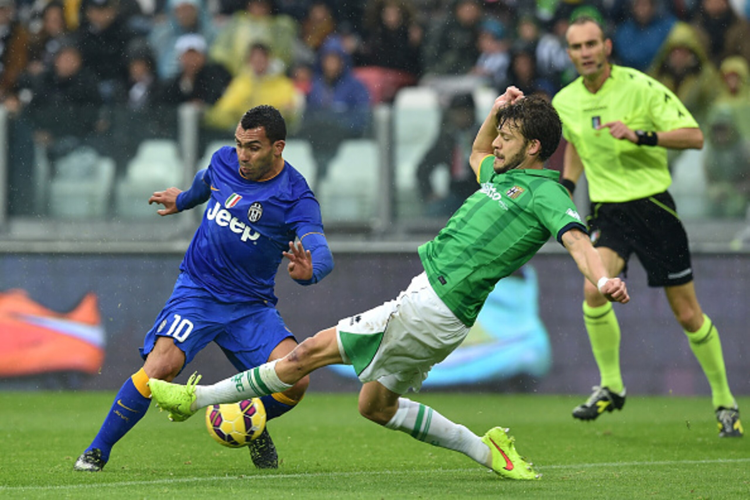 TURIN, ITALY - NOVEMBER 09: Carlos Tevez (L) of Juventus FC is tackled by Andrea Costa of Parma FC during the Serie A match between Juventus FC and Parma FC at Juventus Arena on November 9, 2014 in Turin, Italy. (Photo by Valerio Pennicino/Getty Images) TURIN, ITALY - NOVEMBER 09: Carlos Tevez (L) of Juventus FC is tackled by Andrea Costa of Parma FC during the Serie A match between Juventus FC and Parma FC at Juventus Arena on November 9, 2014 in Turin, Italy. (Photo by Valerio Pennicino/Getty Images)