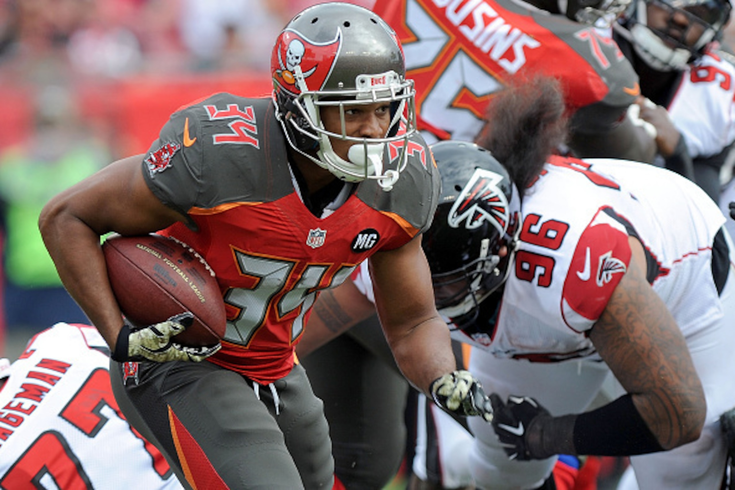 TAMPA, FL - NOVEMBER 09: Charles Sims #34 of the Tampa Bay Buccaneers carries during the second quarter of the game against the Atlanta Falcons at Raymond James Stadium on November 9, 2014 in Tampa, Florida. (Photo by Cliff McBride/Getty Images)