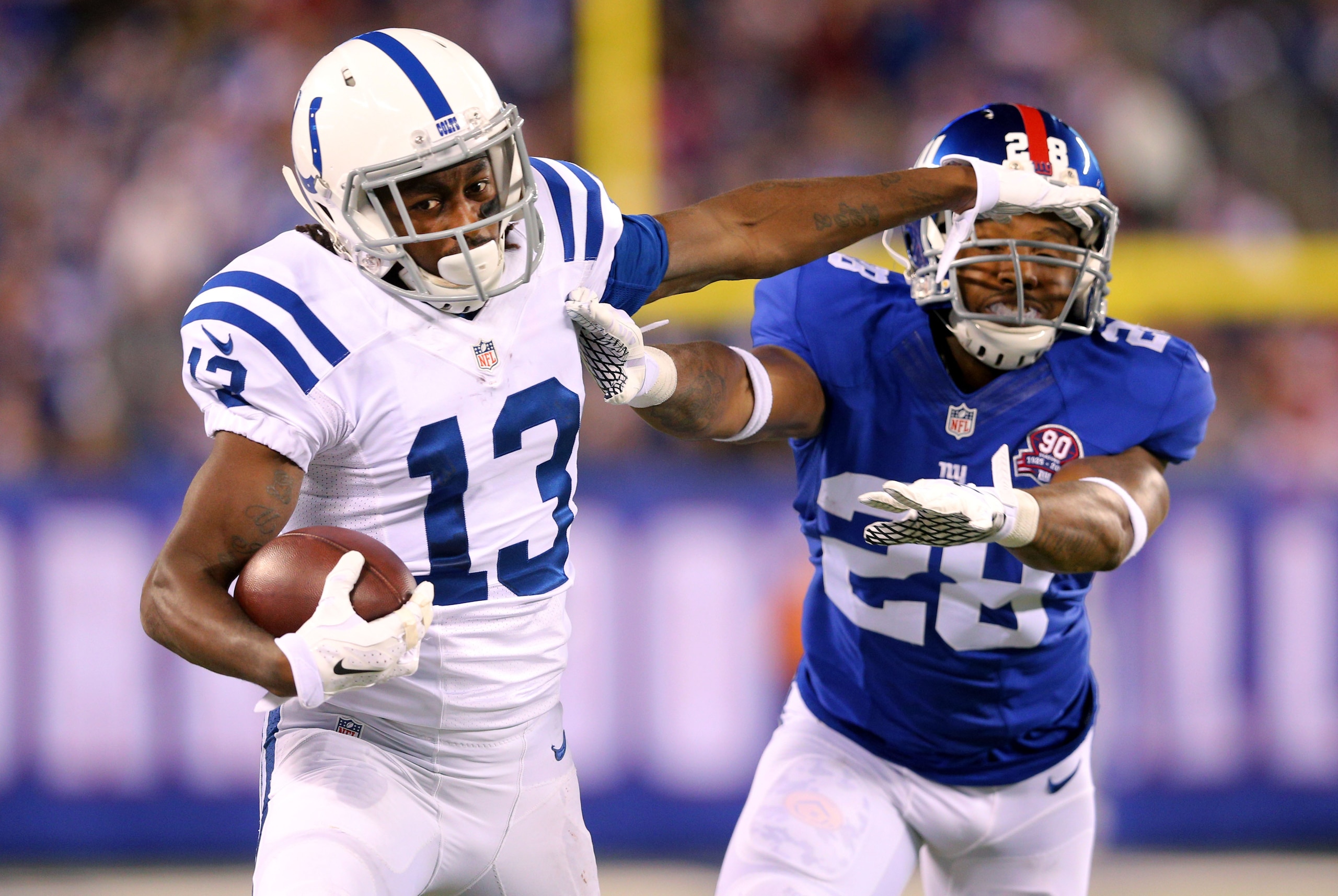 Nov 3, 2014; East Rutherford, NJ, USA; Indianapolis Colts wide receiver T.Y. Hilton (13) stiff-arms New York Giants corner back Jayron Hosley (28) after a catch during the second quarter at MetLife Stadium. Mandatory Credit: Brad Penner-USA TODAY Sports