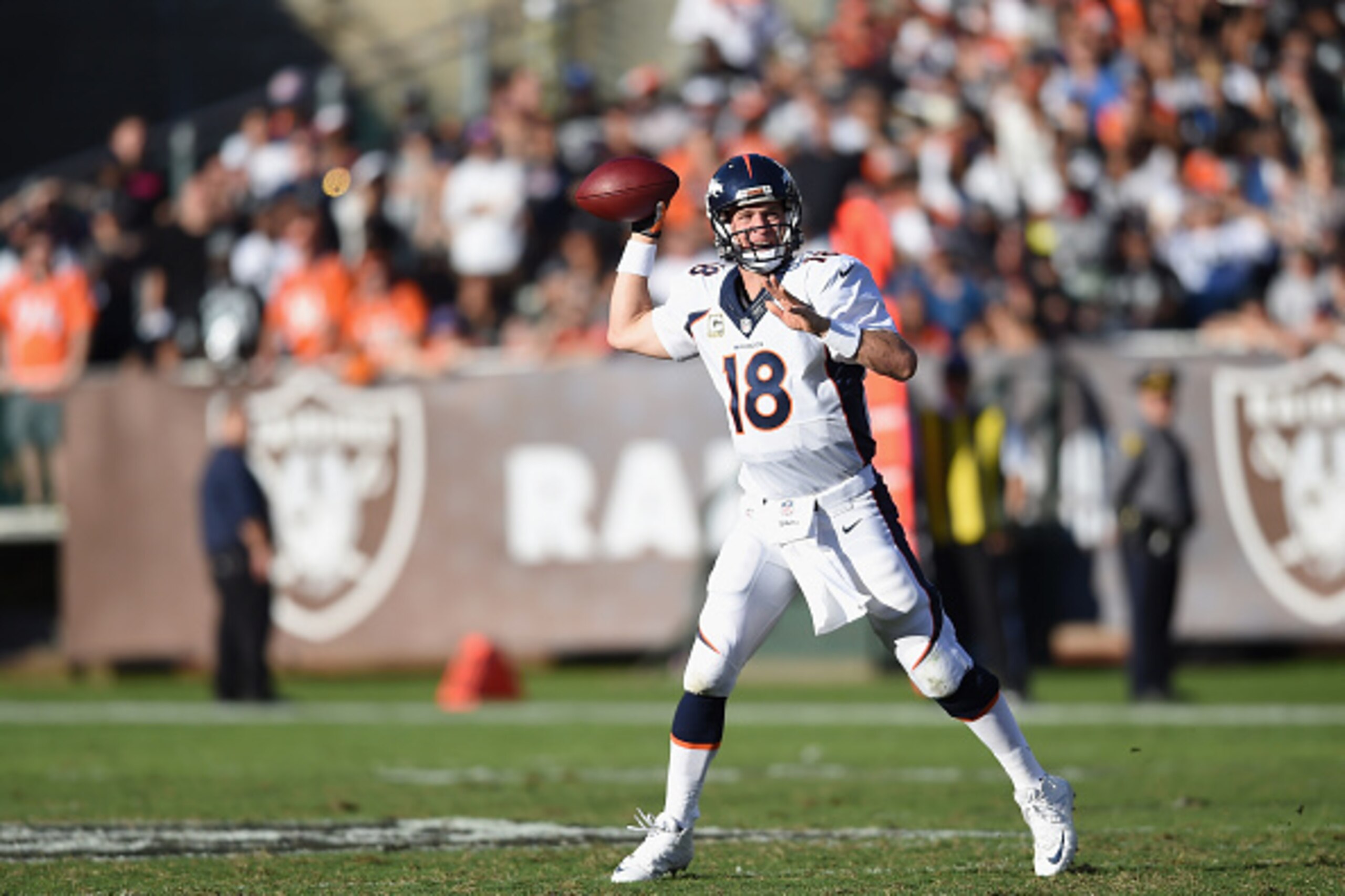 OAKLAND, CA - NOVEMBER 09: Peyton Manning #18 of the Denver Broncos passes against the Oakland Raiders in the first half at O.co Coliseum on November 9, 2014 in Oakland, California. (Photo by Thearon W. Henderson/Getty Images)