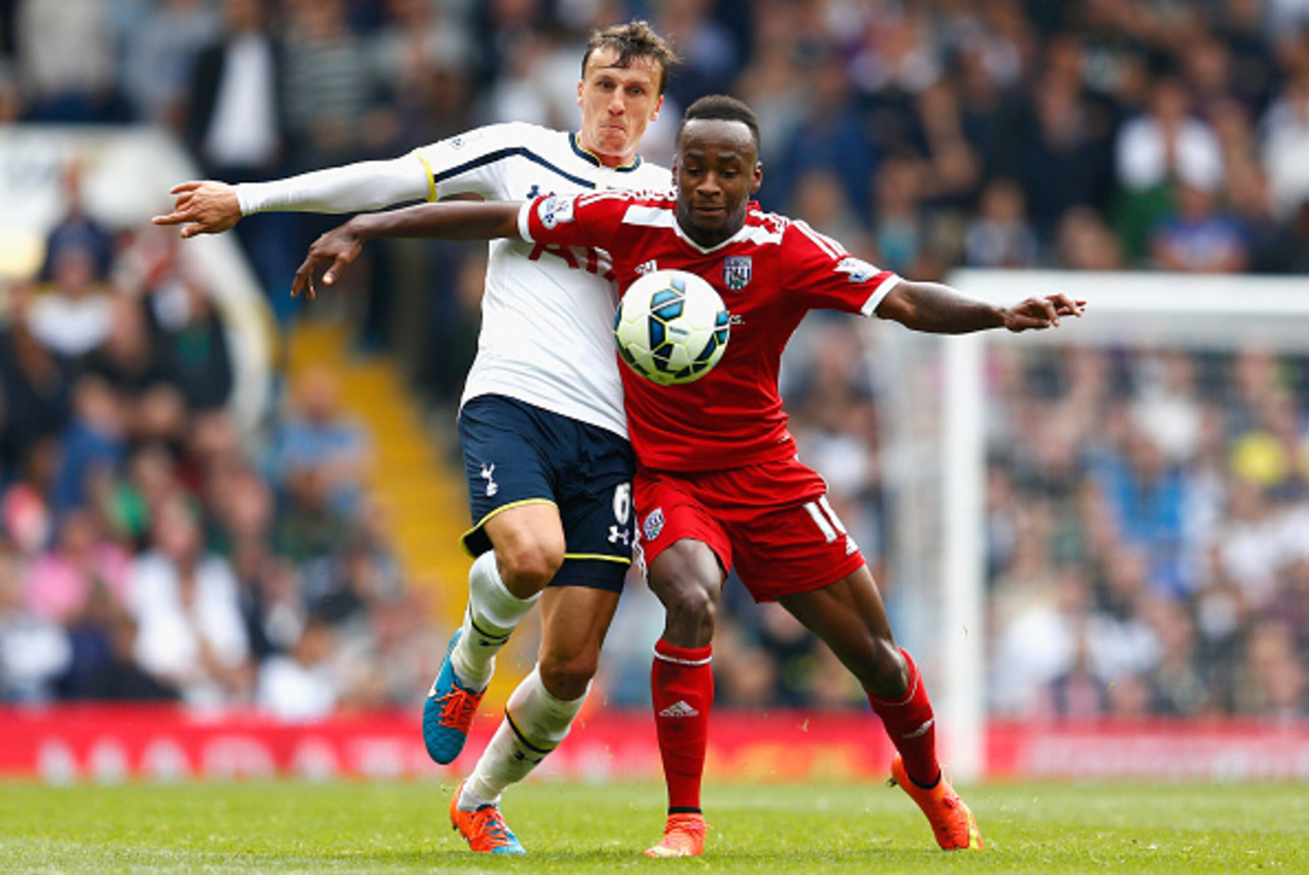 LONDON, ENGLAND - SEPTEMBER 21: Vlad Chiriches of Spurs is challehned by Saido Berahino of West Brom during the Barclays Premier League match between Tottenham Hotspur and West Bromwich Albion at White Hart Lane on September 21, 2014 in London, England. LONDON, ENGLAND - SEPTEMBER 21: Vlad Chiriches of Spurs is challehned by Saido Berahino of West Brom during the Barclays Premier League match between Tottenham Hotspur and West Bromwich Albion at White Hart Lane on September 21, 2014 in London, England.