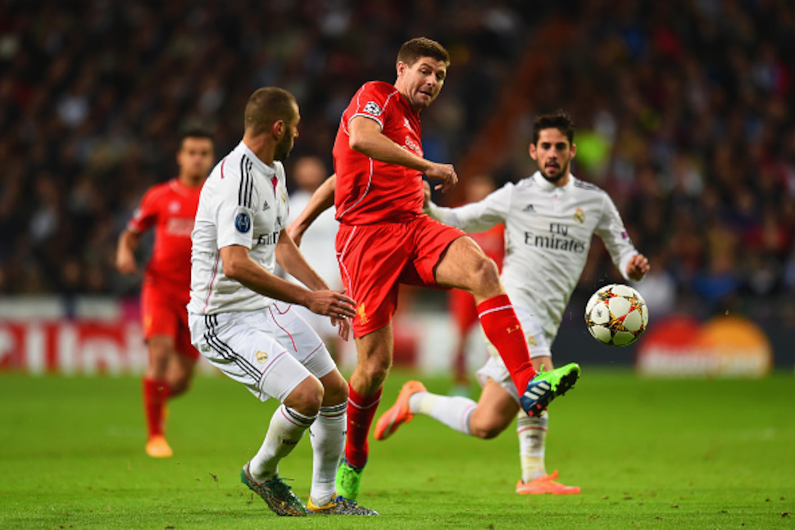 MADRID, SPAIN - NOVEMBER 04: Steven Gerrard of Liverpool kicks the ball under pressure from Karim Benzema of Real Madrid CF during the UEFA Champions League Group B match between Real Madrid CF and Liverpool FC at Estadio Santiago Bernabeu on November 4, MADRID, SPAIN - NOVEMBER 04: Steven Gerrard of Liverpool kicks the ball under pressure from Karim Benzema of Real Madrid CF during the UEFA Champions League Group B match between Real Madrid CF and Liverpool FC at Estadio Santiago Bernabeu on November 4,