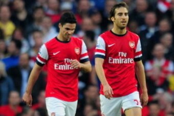 LONDON, ENGLAND - MARCH 29:  A dejected Santi Cazorla, Mikel Arteta and Mathieu Flamini of Arsenal after conceding the first goal during the Barclays Premier League match between Arsenal and Manchester City at Emirates Stadium on March 29, 2014 in London,