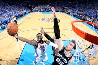 OKLAHOMA CITY, OK  MAY 25: Reggie Jackson #15 of the Oklahoma City Thunder shoots against Tiago Splitter #22 of the San Antonio Spurs in Game Three of the Western Conference Finals during the 2014 NBA Playoffs on May 25, 2014 at the Chesapeake Energy Aren