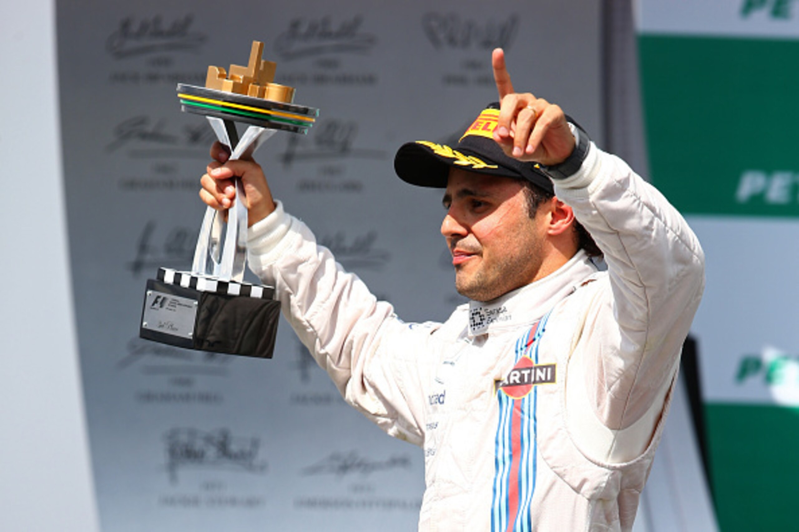 SAO PAULO, BRAZIL - NOVEMBER 09:  Felipe Massa of Brazil and Williams celebrates on the podium after finishing third in the Brazilian Formula One Grand Prix at Autodromo Jose Carlos Pace on November 9, 2014 in Sao Paulo, Brazil.  (Photo by Mark Thompson/G