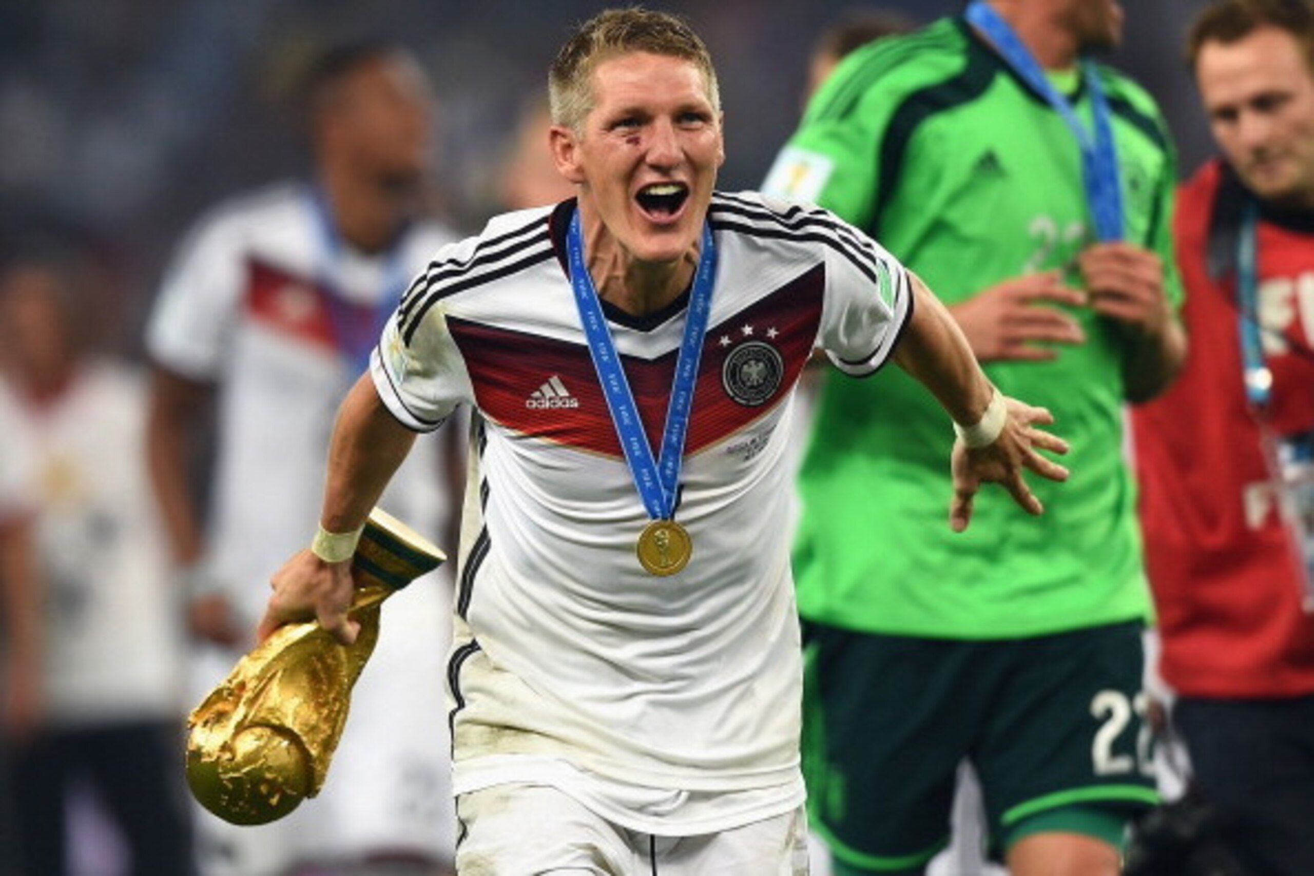 RIO DE JANEIRO, BRAZIL - JULY 13:  Bastian Schweinsteiger  of Germany celebrates with the World Cup trophy  after defeating Argentina 1-0 in extra time during the 2014 FIFA World Cup Brazil Final match between Germany and Argentina at Maracana on July 13,