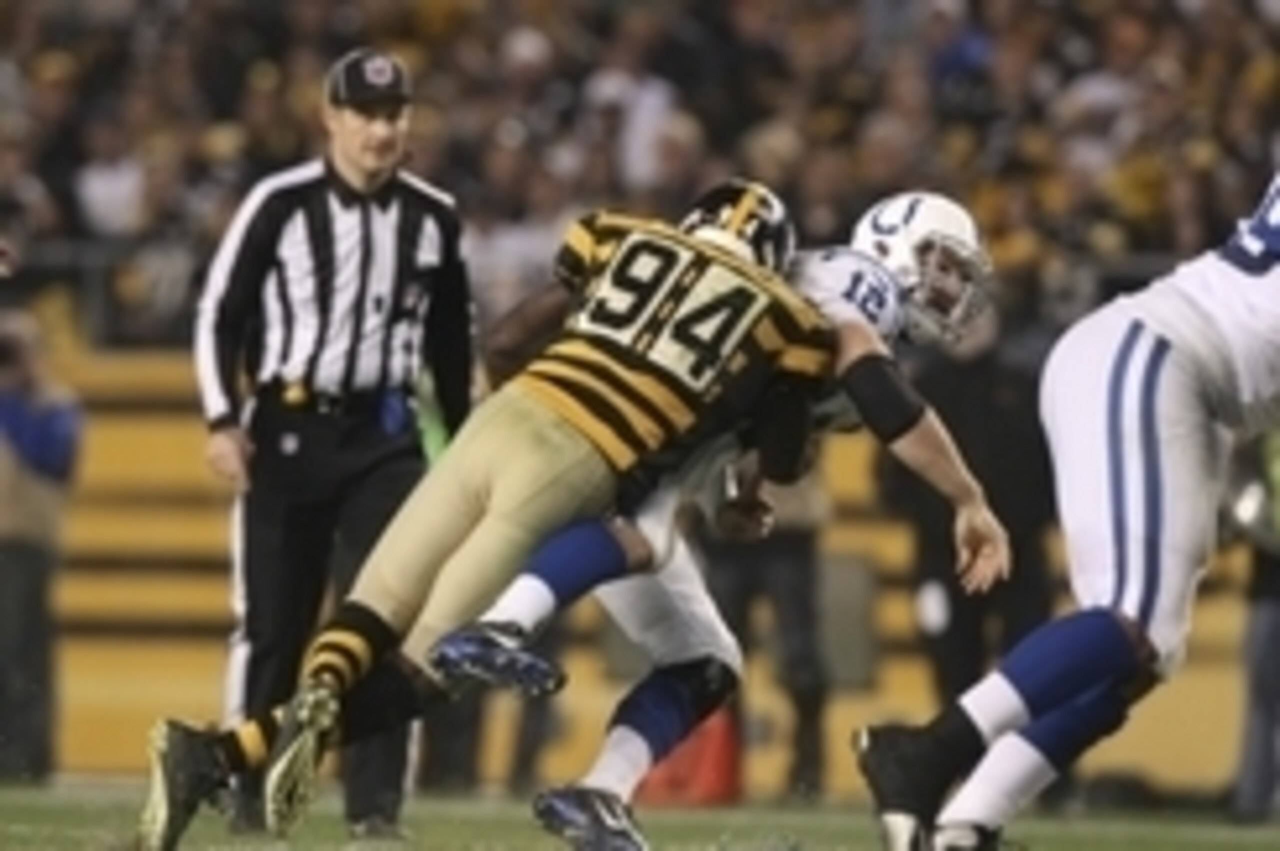 Oct 26, 2014; Pittsburgh, PA, USA; Indianapolis Colts quarterback Andrew Luck (12) is hit by Pittsburgh Steelers linebacker Lawrence Timmons (94) as he throws a pass during the second half of their game at Heinz Field. The Steelers won the game, 51-34. Ma