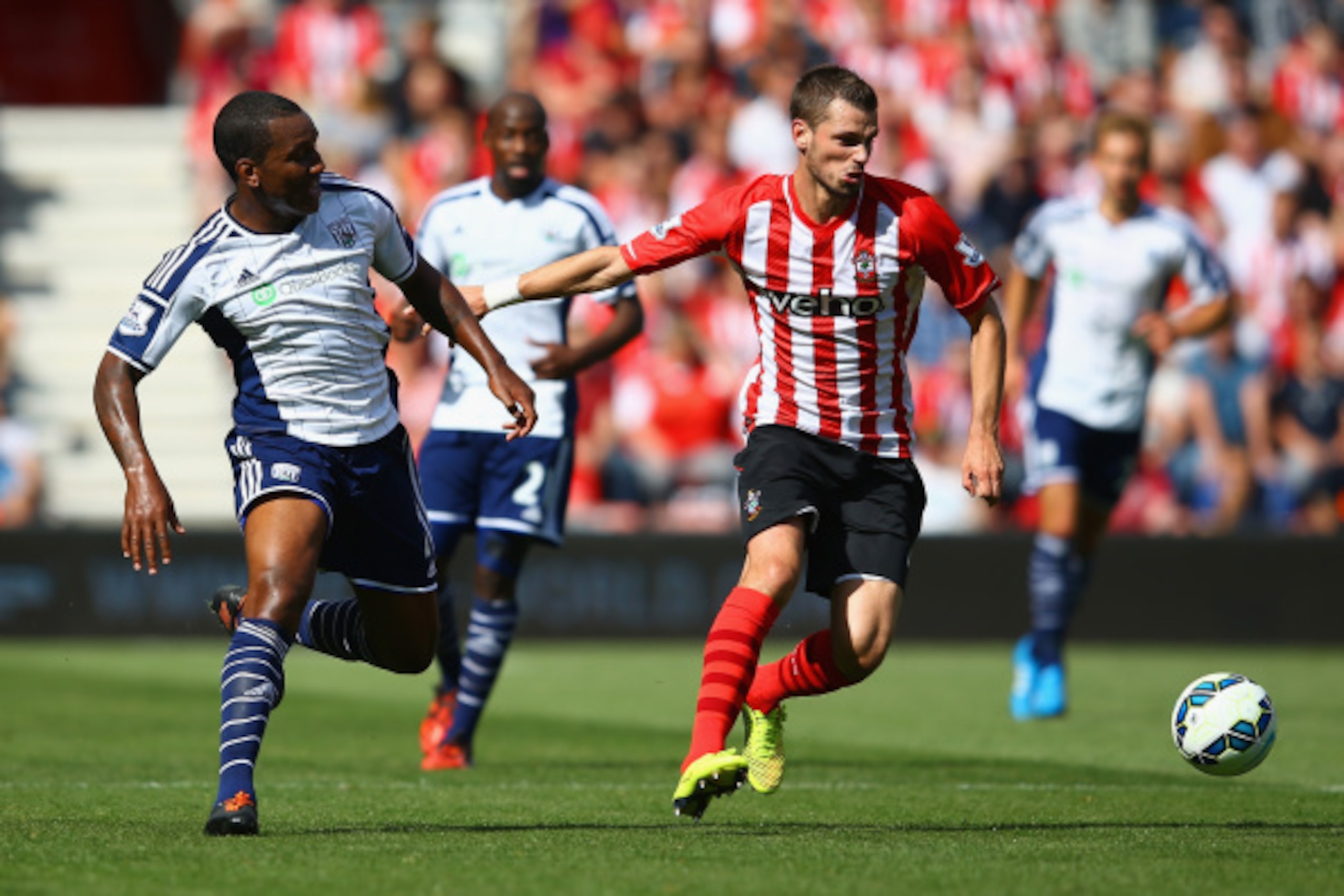 SOUTHAMPTON, ENGLAND - AUGUST 23: Morgan Schneiderlin of Southampton holds off a challenge from Andre Wisdom of West Brom during the Barclays Premier League match between Southampton and West Bromwich Albion at St Mary's Stadium on August 23, 2014 in Sout