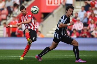 SOUTHAMPTON, ENGLAND - SEPTEMBER 13:  Morgan Schneiderlin of Southampton shoots past Daryl Janmaat of Newcastle United to score their fourth goal during the Barclays Premier League match between Southampton and Newcastle United at St Mary's Stadium on Sep