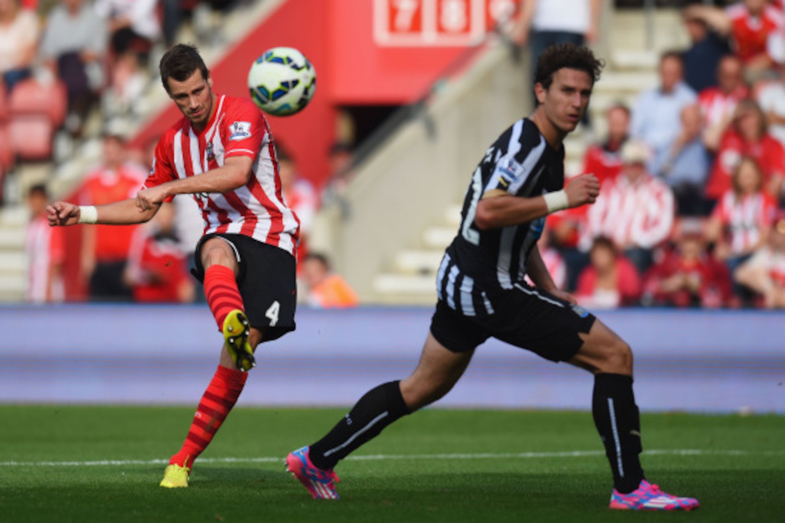 SOUTHAMPTON, ENGLAND - SEPTEMBER 13:  Morgan Schneiderlin of Southampton shoots past Daryl Janmaat of Newcastle United to score their fourth goal during the Barclays Premier League match between Southampton and Newcastle United at St Mary's Stadium on Sep