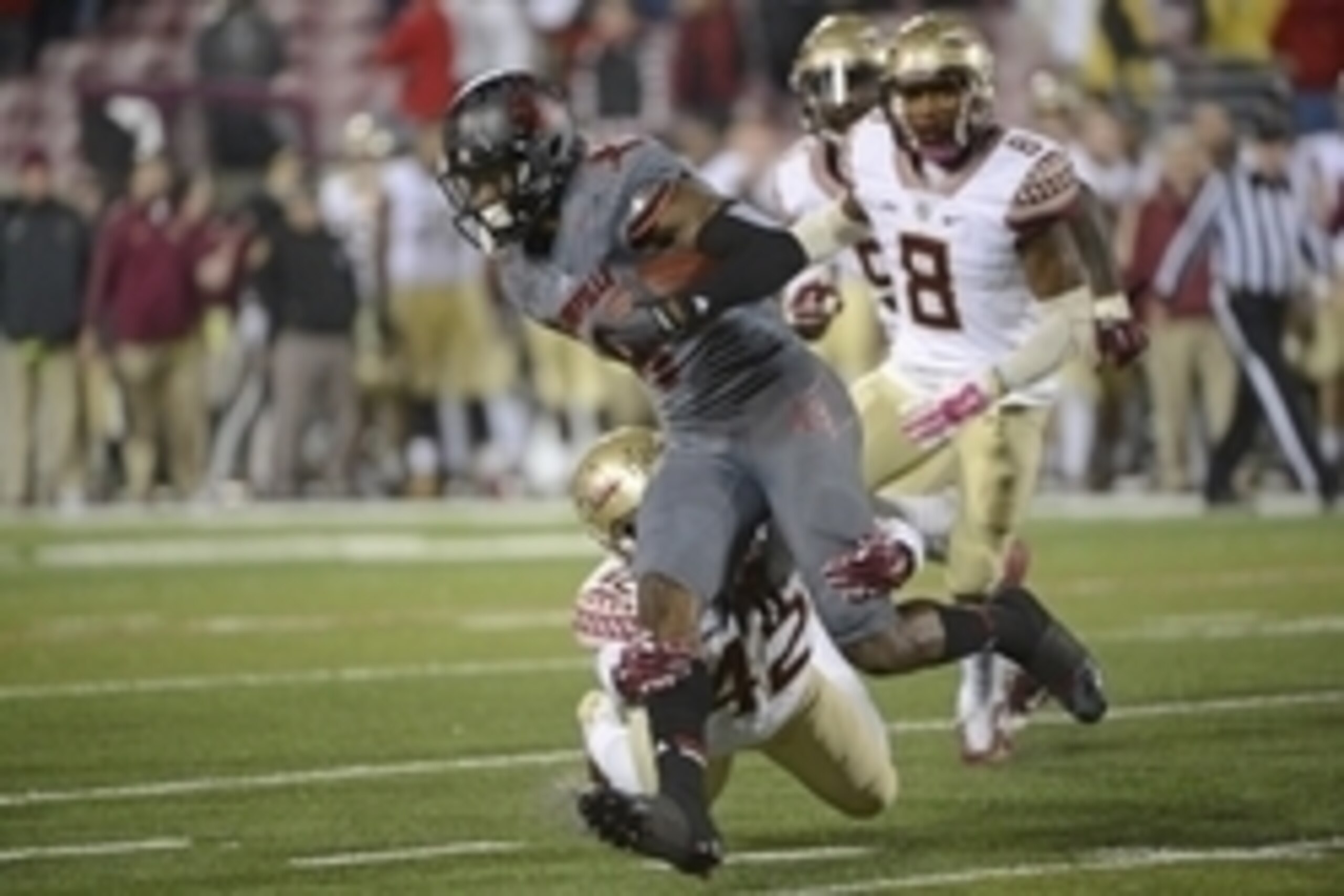 Oct 30, 2014; Louisville, KY, USA; Louisville Cardinals wide receiver DeVante Parker (9) runs the ball against Florida State Seminoles defensive back Lamarcus Brutus (42) during the second half at Papa John's Cardinal Stadium. Florida State defeated Louis