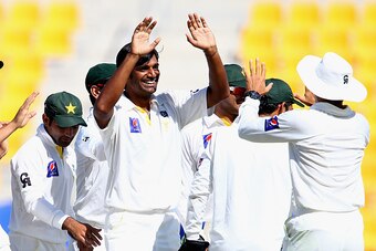 ABU DHABI, UNITED ARAB EMIRATES - NOVEMBER 11:  Rahat Ali of Pakistan celebrates with teammates after dismissing Kane Williamson during Day Three of the First Test between Pakistan and New Zealand at Sheikh Zayed stadium on November 11, 2014 in Abu Dhabi,