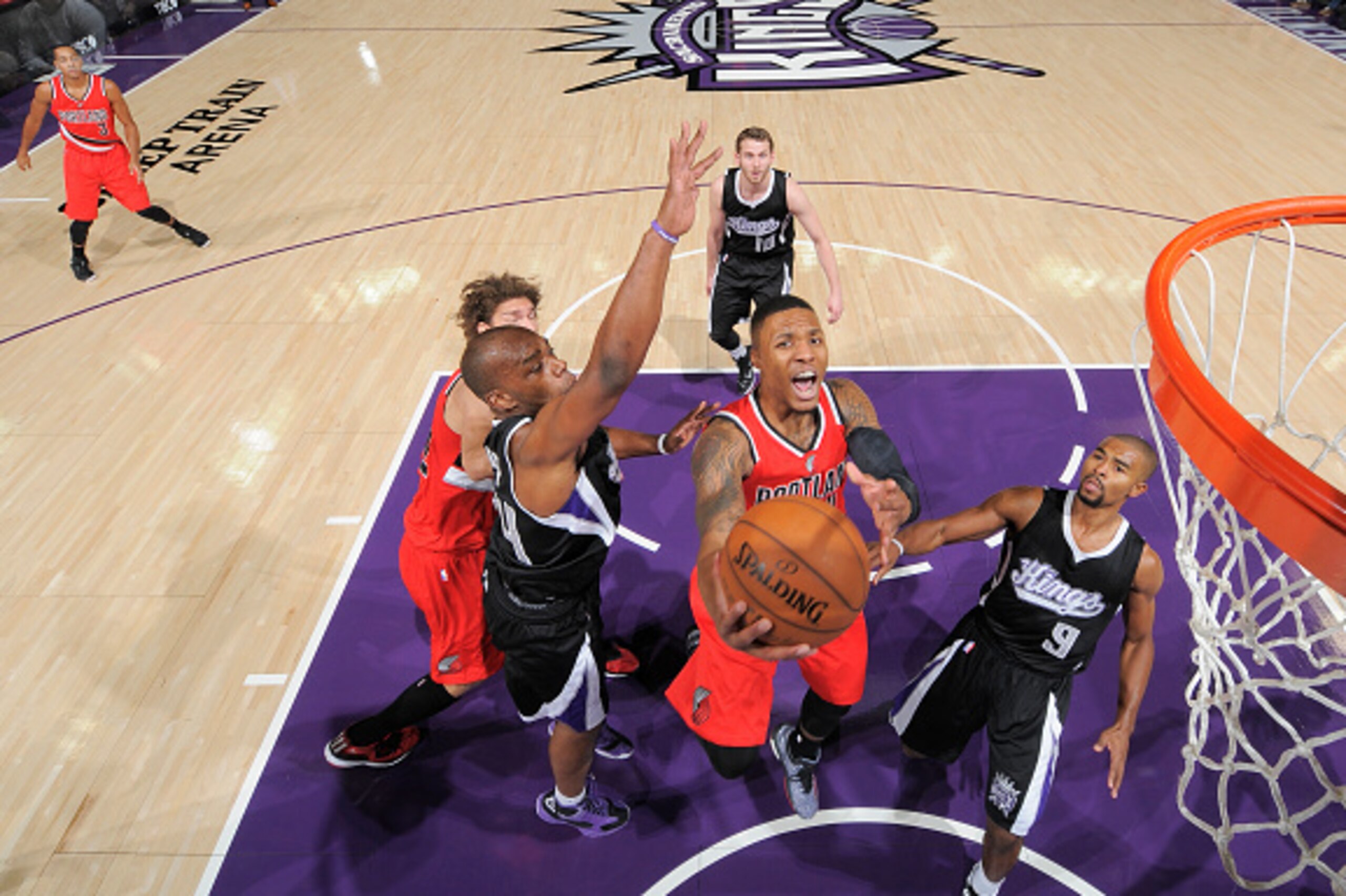 SACRAMENTO, CA - OCTOBER 31: Damian Lillard #0 of the Portland Trail Blazers shoots a layup against Carl Landry #24 of the Sacramento Kings on October 31, 2014 at Sleep Train Arena in Sacramento, California. NOTE TO USER: User expressly acknowledges and a