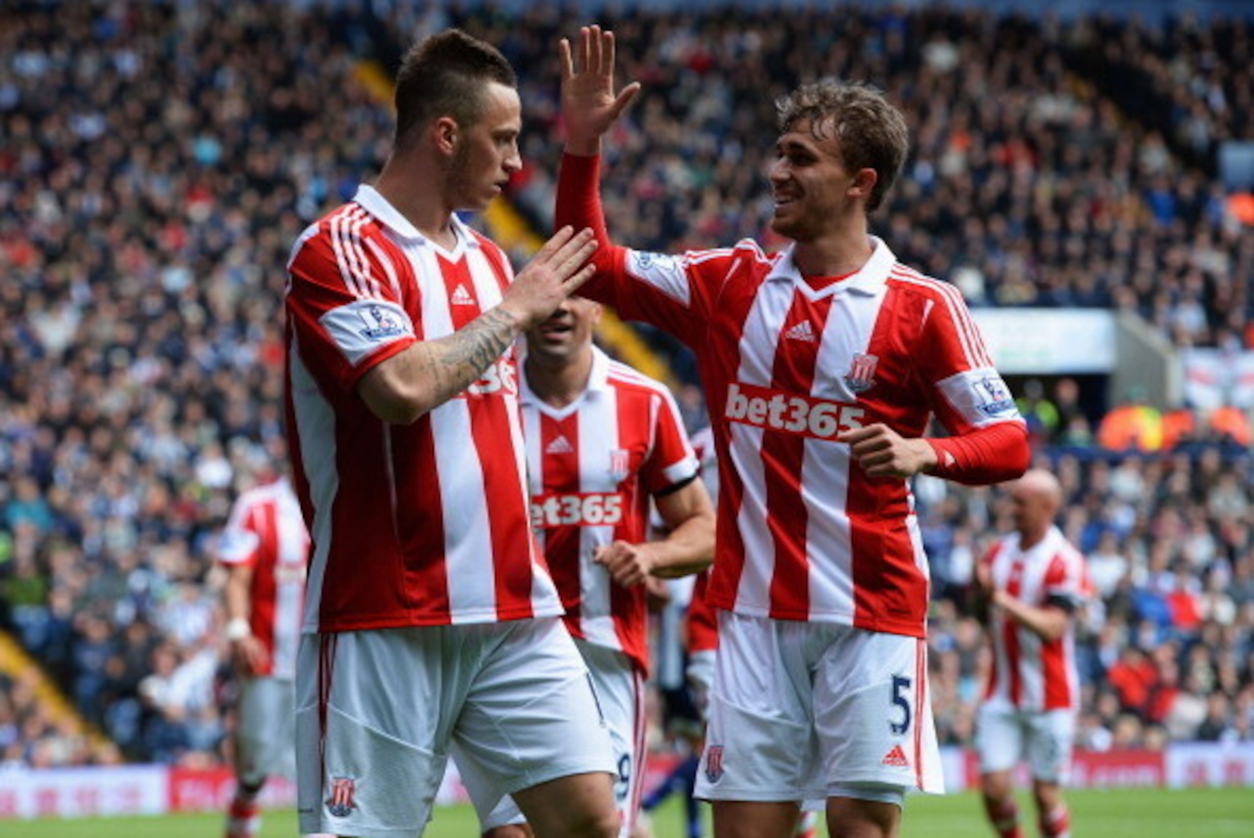 WEST BROMWICH, ENGLAND - MAY 11:  Marko Arnautovic (L) and Marc Muniesa of Stoke City  celebrate an own goal by Gareth McAuley of West Bromwich Albion (not pictured) during the Barclays Premier League match between West Bromwich Albion and Stoke City at T