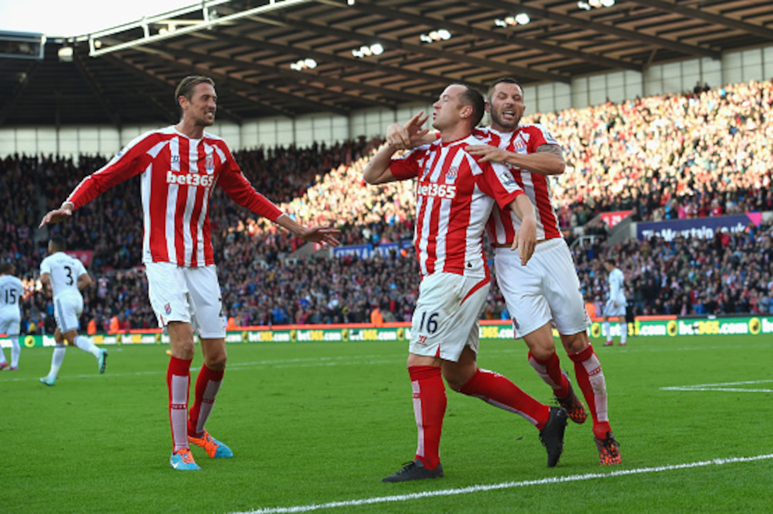 STOKE ON TRENT, ENGLAND - OCTOBER 19:  Stoke player Charlie Adam (c) is congratulated by team mates after scoring during the Barclays Premier League match between Stoke City and Swansea City at Britannia Stadium on October 19, 2014 in Stoke on Trent, Engl