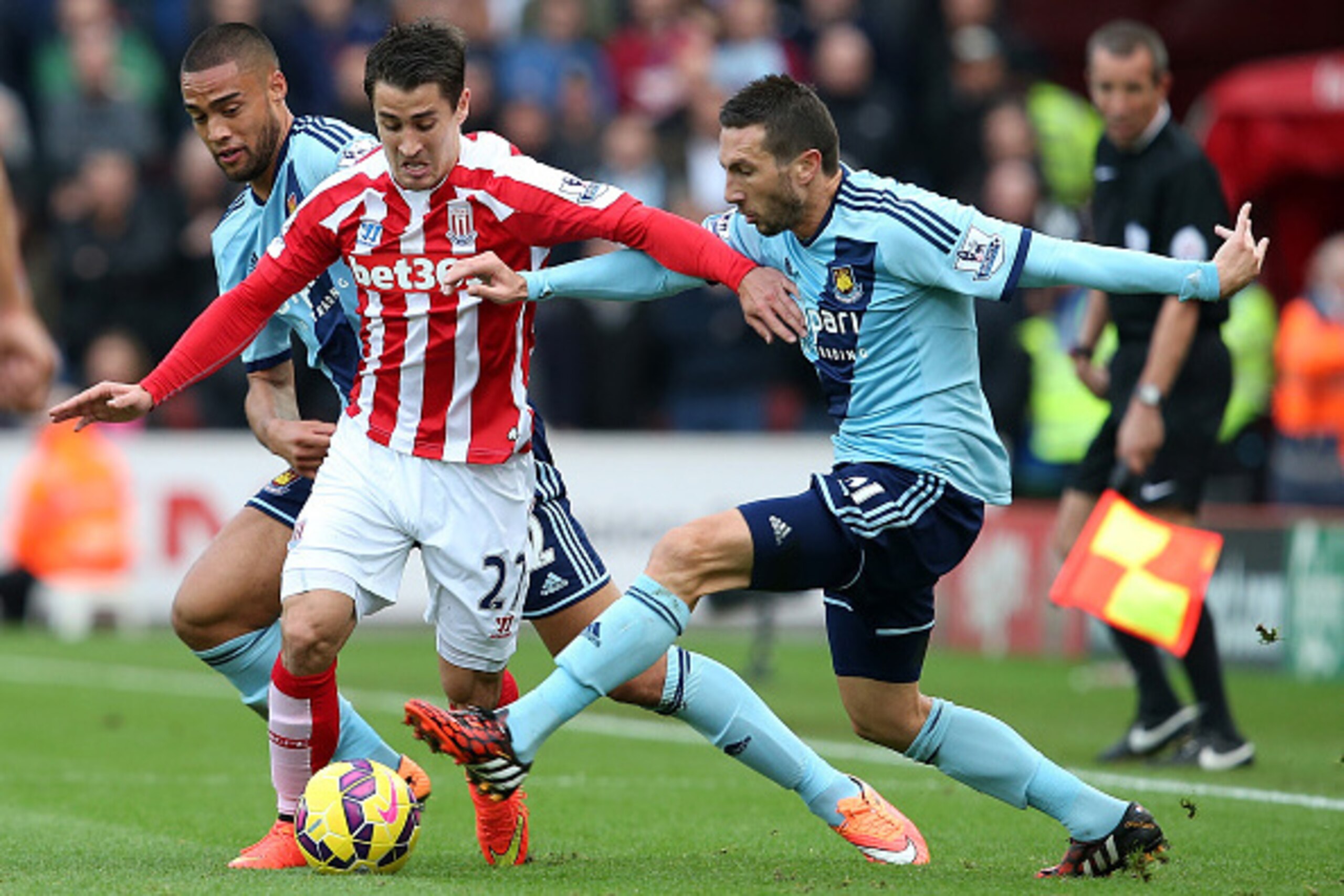 STOKE ON TRENT, ENGLAND - NOVEMBER 01:  Bojan of Stoke City is challenged by Winston Reid (L) and Morgan Amalfitano of West Ham during the Barclays Premier League match between Stoke City and West Ham United at the Britannia Stadium on November 1, 2014 in