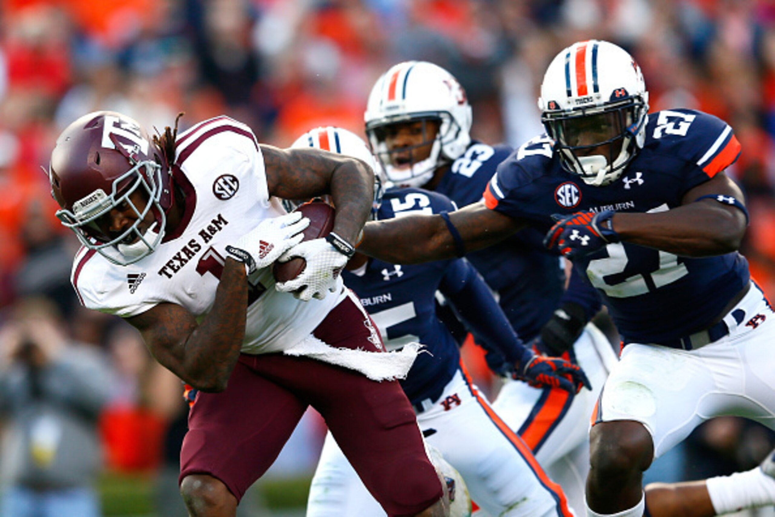 AUBURN, AL - NOVEMBER 08:  Brandon Williams #1 of the Texas A&M Aggies breaks a tackle by Robenson Therezie #27 of the Auburn Tigers at Jordan Hare Stadium on November 8, 2014 in Auburn, Alabama.  (Photo by Kevin C. Cox/Getty Images)