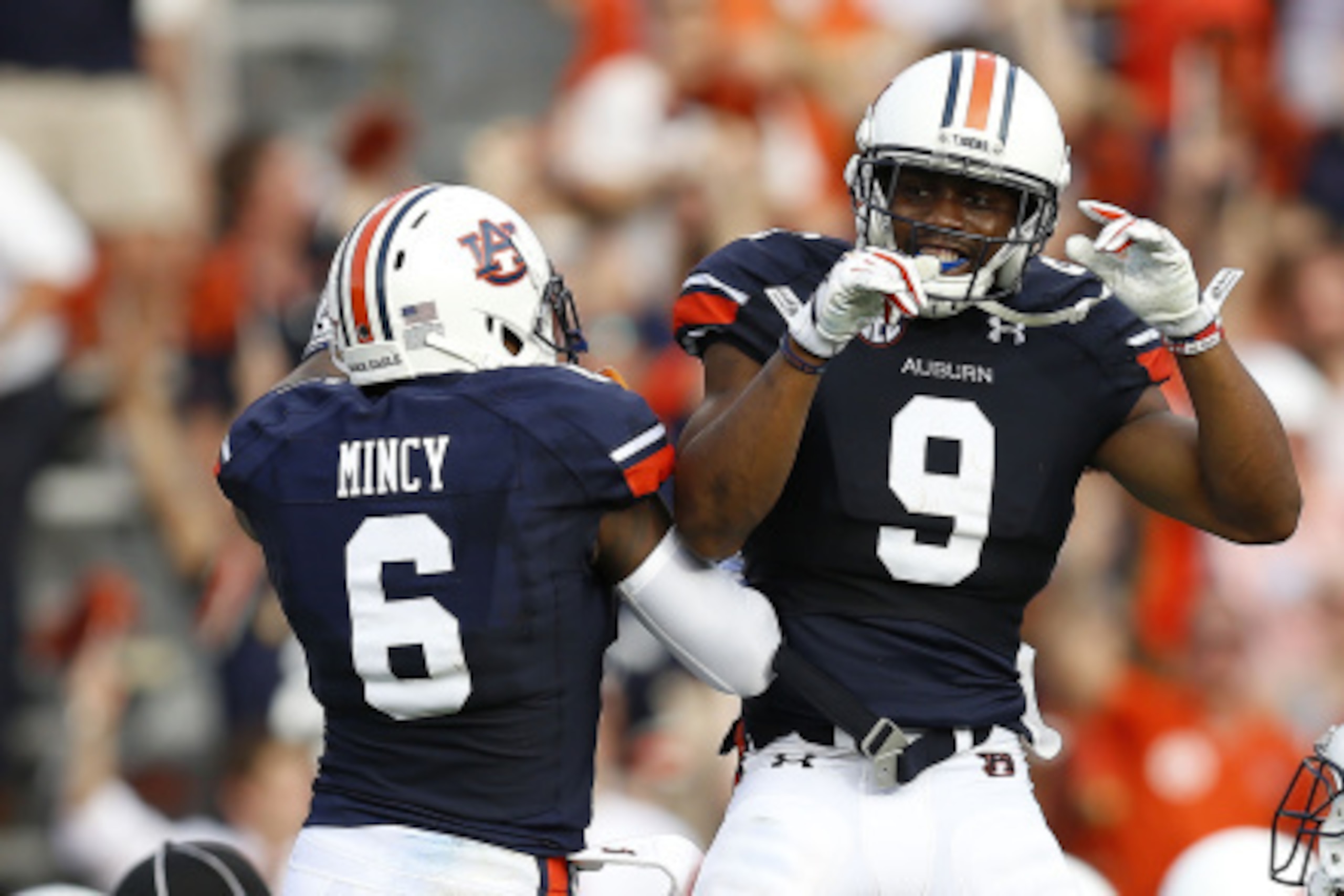 AUBURN, AL - AUGUST 30:  Defensive back Jermaine Whitehead #9 of the Auburn Tigers celebrates his interception for a touchdown with defensive back Jonathan Mincy #6 during the game against the Arkansas Razorbacks at Jordan Hare Stadium on August 30, 2014 