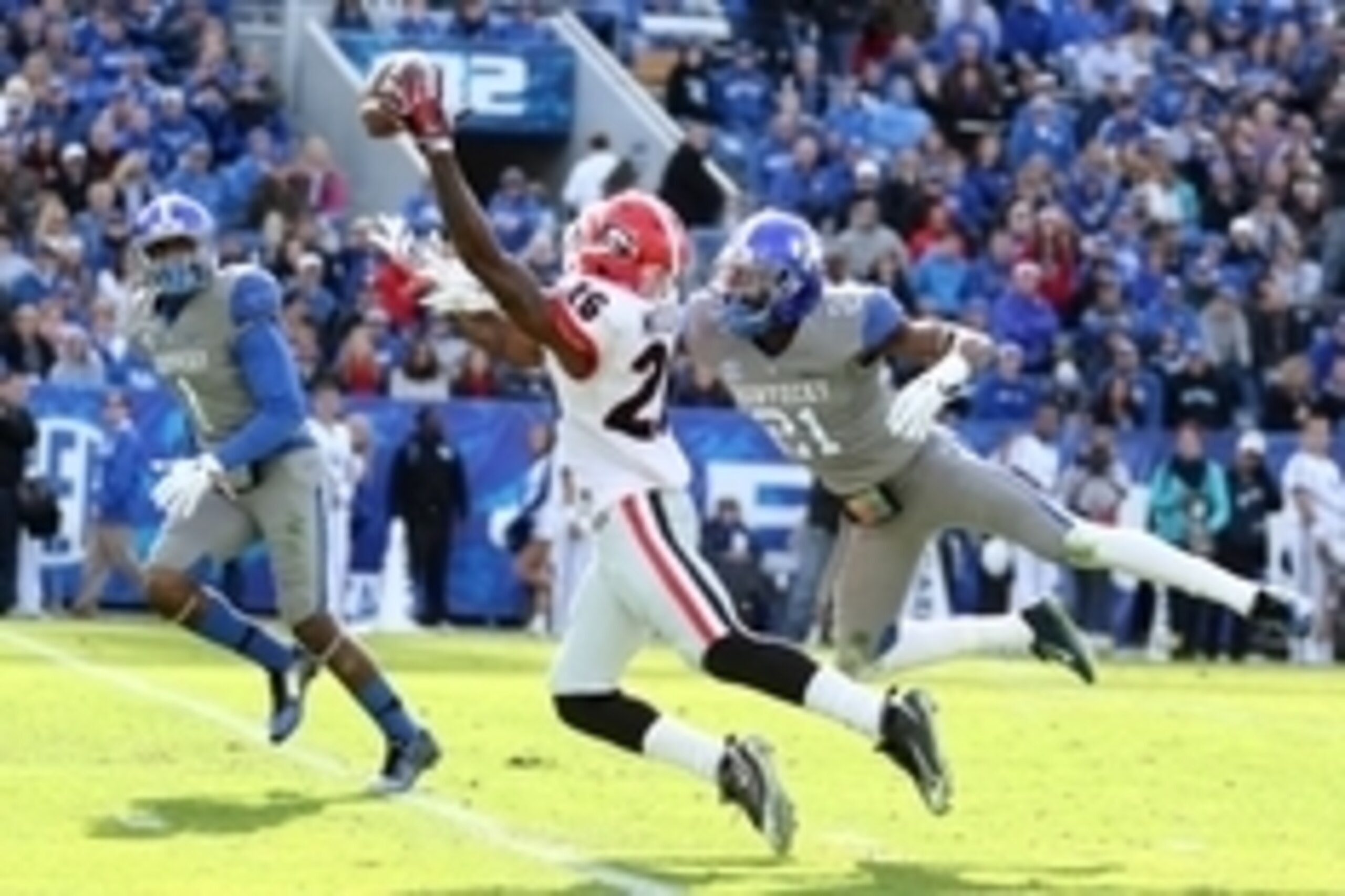 Nov 8, 2014; Lexington, KY, USA; Georgia Bulldogs split end Malcolm Mitchell (26) catches a pass against Kentucky Wildcats running back Josh Clemons (21) and safety A.J. Stamps (1) in the second half at Commonwealth Stadium. Mandatory Credit: Mark Zerof-U