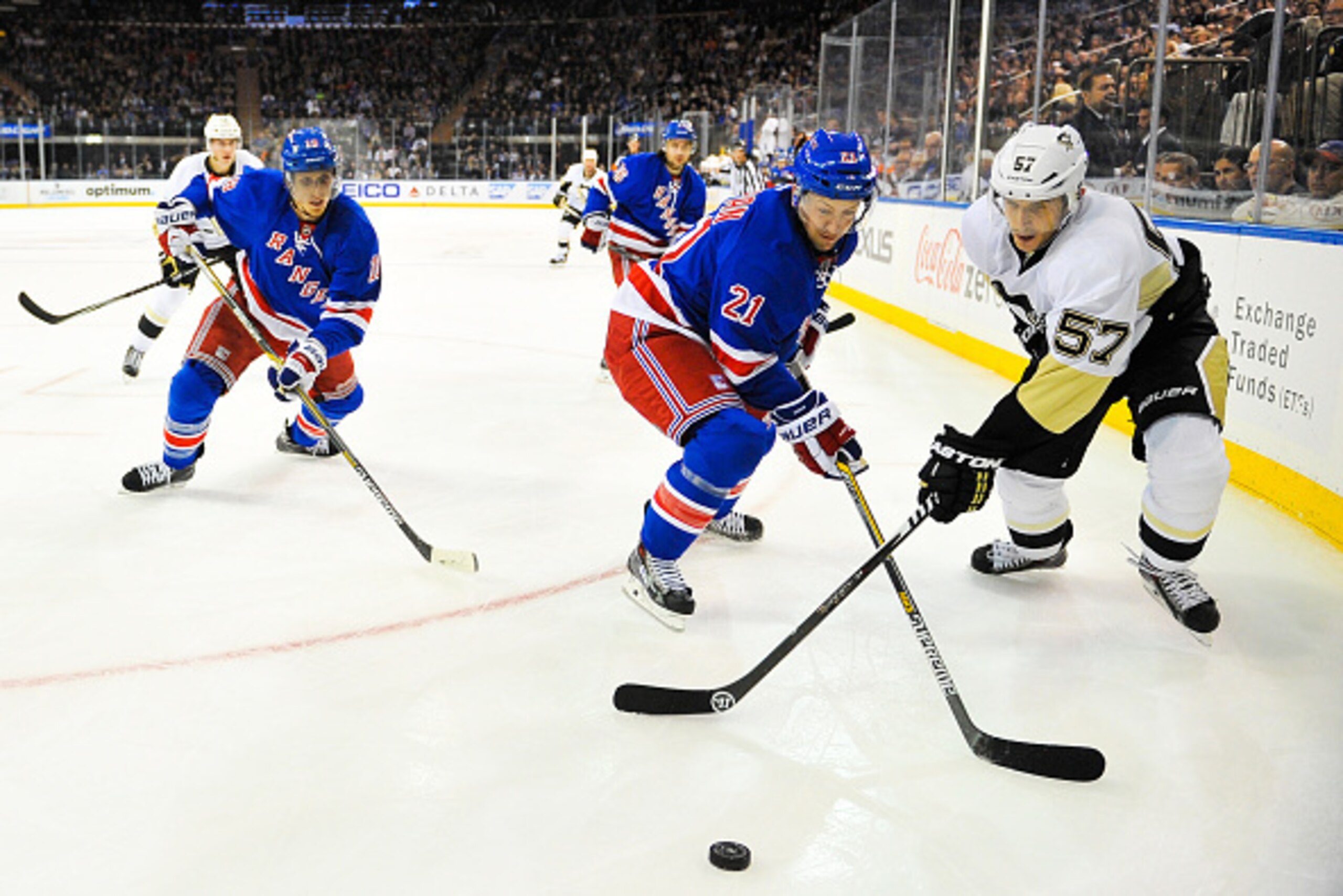 NEW YORK, NY - NOVEMBER 11: Derek Stepan #21 of the New York Rangers fights for the puck with Marcel Goc #57 of the Pittsburgh Penguins in the first period at Madison Square Garden on November 11, 2014 in New York City.  (Photo by Alex Goodlett/Getty Imag