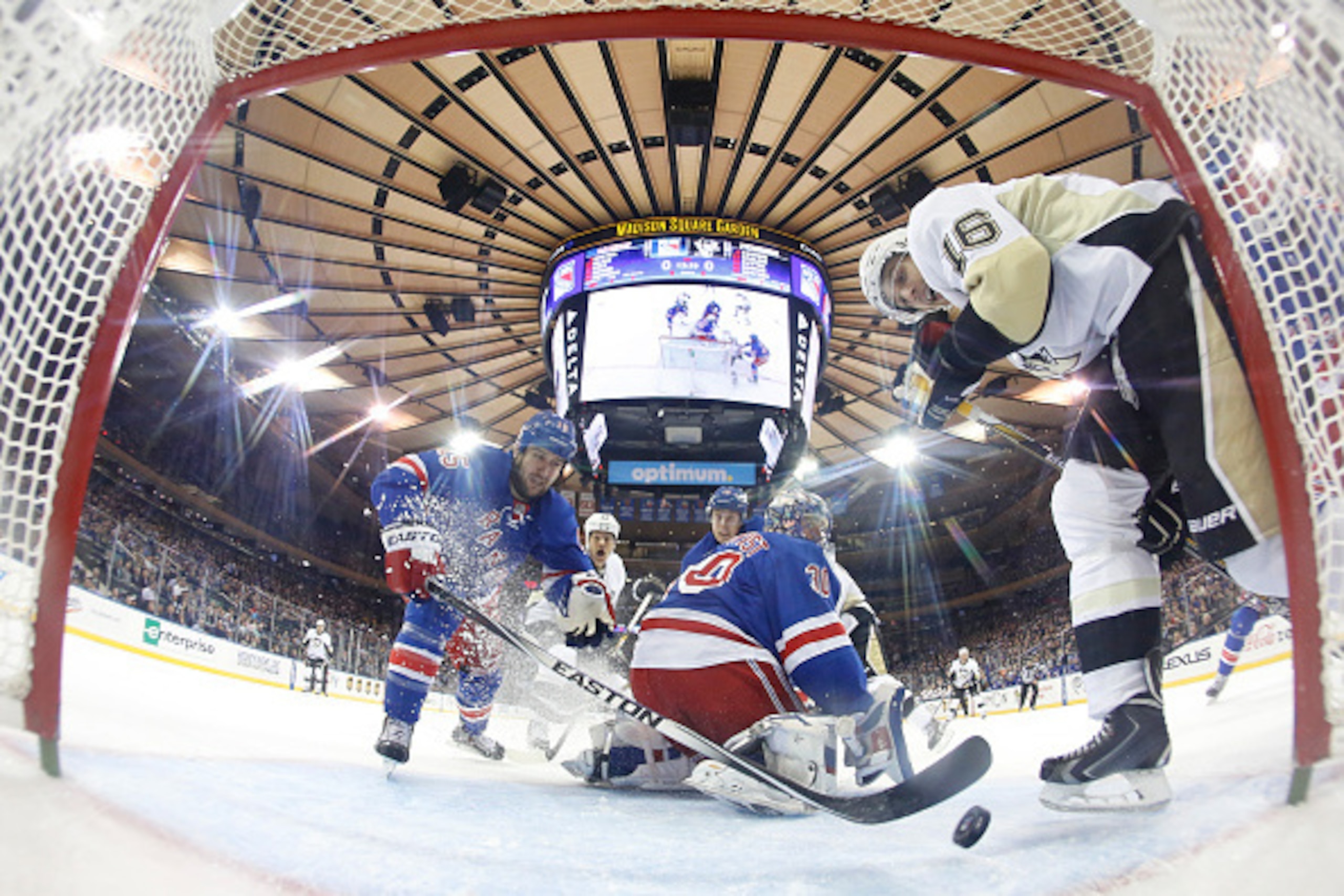 NEW YORK, NY - NOVEMBER 11:  Tanner Glass #15 of the New York Rangers clears the puck away from the net against the Pittsburgh Penguins at Madison Square Garden on November 11, 2014 in New York City.  (Photo by Jared Silber/NHLI via Getty Images)