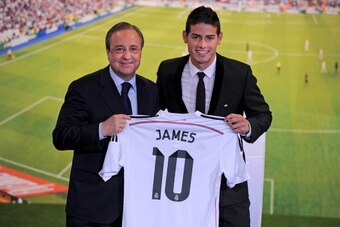 MADRID, SPAIN - JULY 22:  James Rodriguez holds his new Real shirt beside club president Florentino Perez during his unveiling as a new Real Madrid player at the Santaigo Bernabeu stadium on July 22, 2014 in Madrid, Spain. Real agreed to buy Rodriguez fro