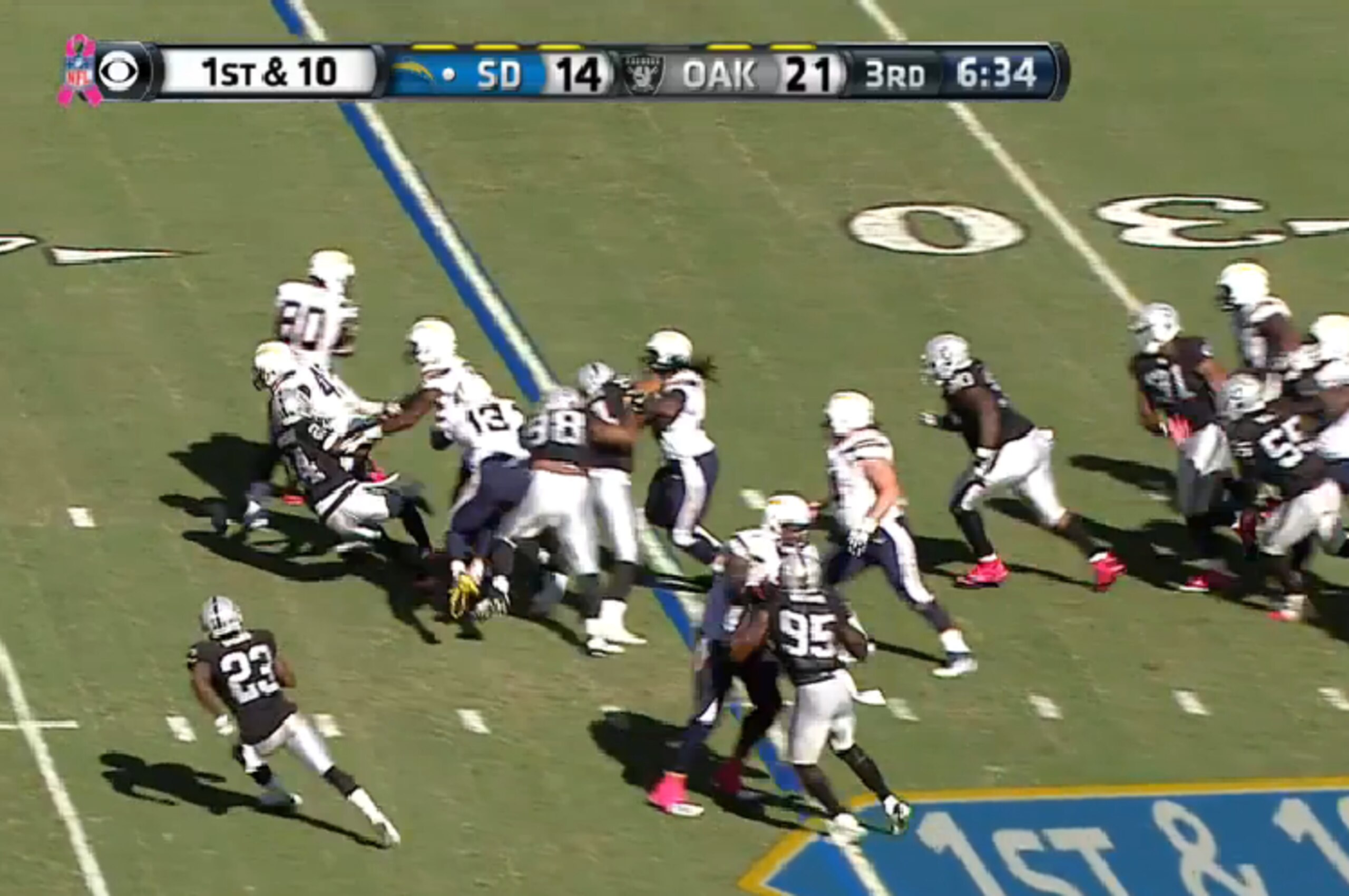 Oliver uses his strength to bowl over Charles Woodson.
