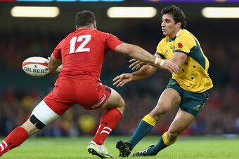 CARDIFF, WALES - NOVEMBER 08:  Nick Phipps (R) of Australia passes as Jamie Roberts (L) of Wales closes in during the International match between Wales and Australia at the Millennium Stadium on November 8, 2014 in Cardiff, Wales.  (Photo by Michael Steel