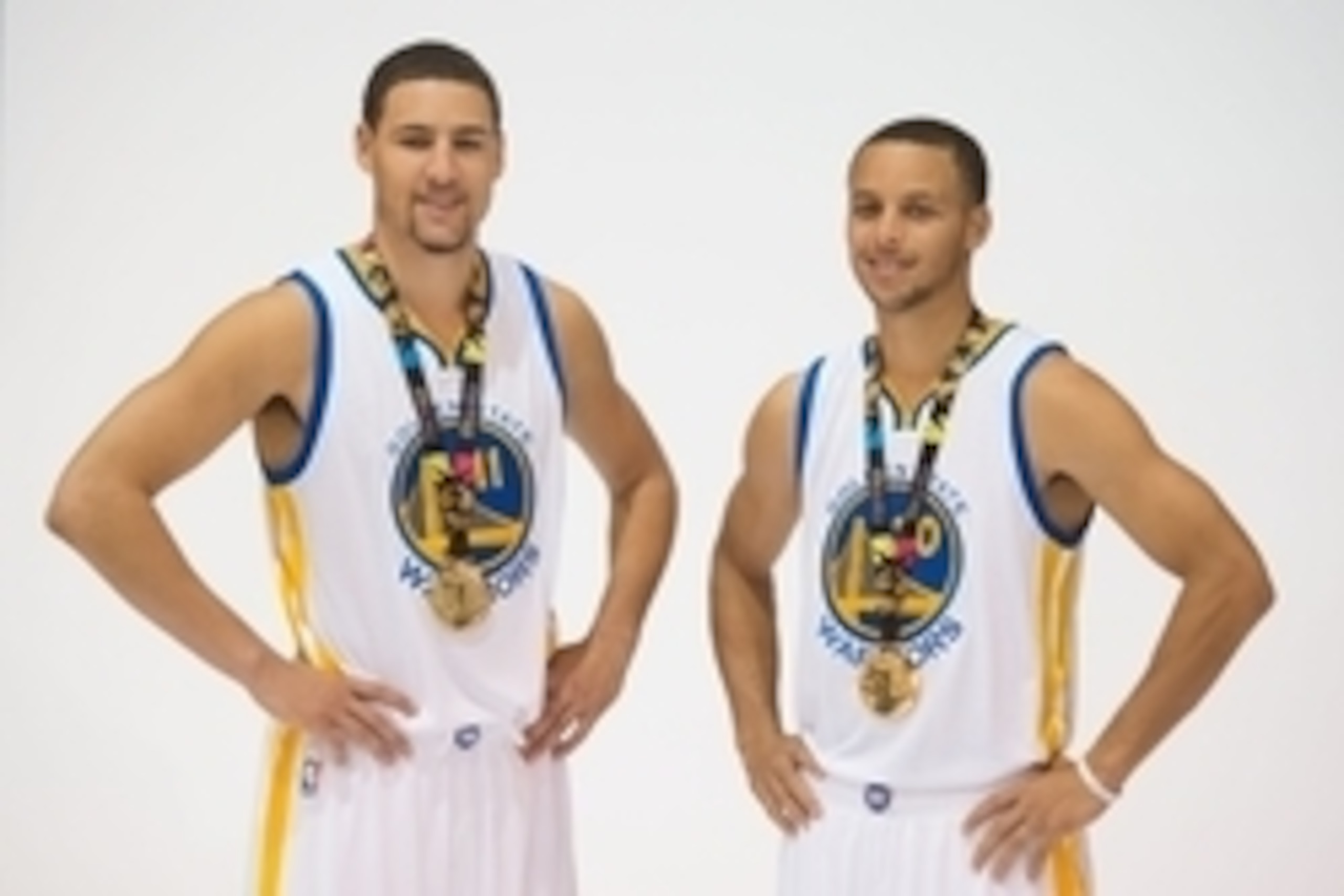 September 29, 2014; Oakland, CA, USA; Golden State Warriors guard Klay Thompson (11) and guard Stephen Curry (30) pose for a photo with their gold medals from the 2014 FIBA Basketball World Cup in Spain during media day at the Warriors Practice Facility.